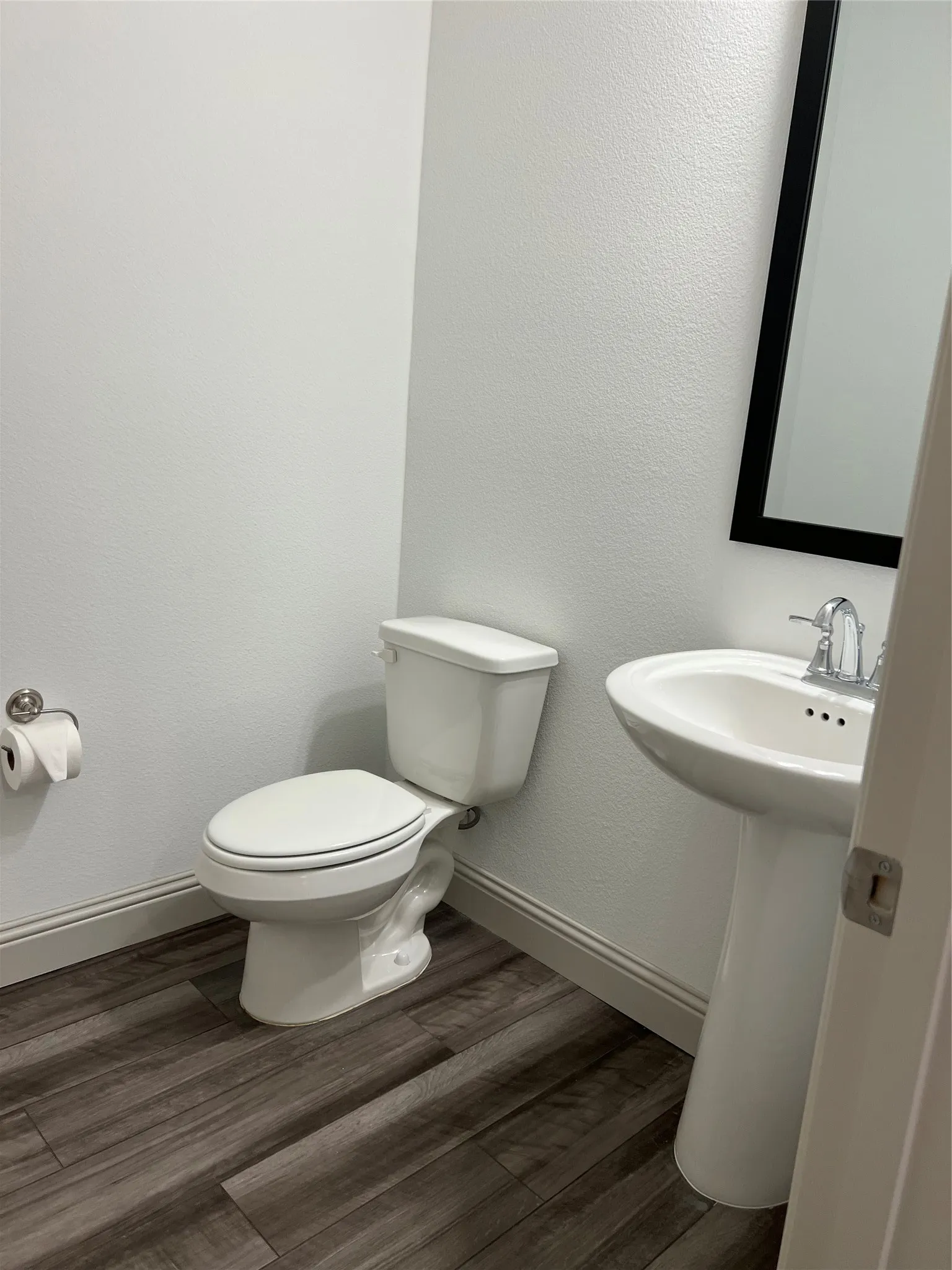 Bathroom featuring hardwood / wood-style floors and toilet
