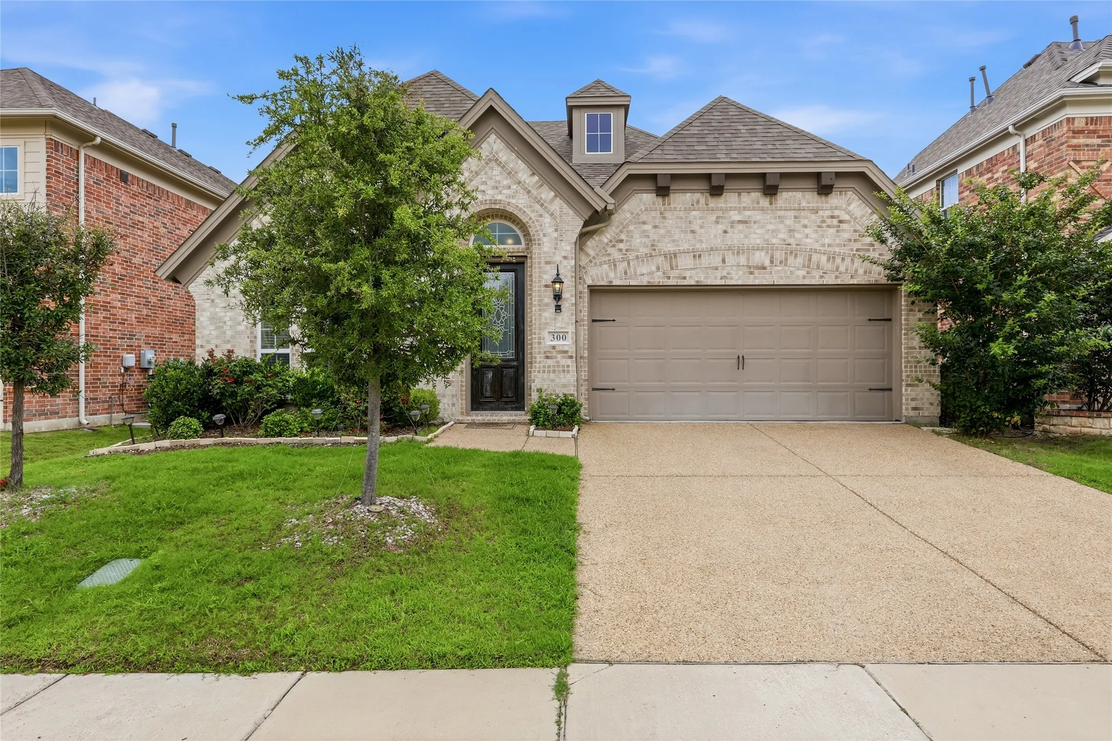 Brick and stone veneer exterior with an arched entryway