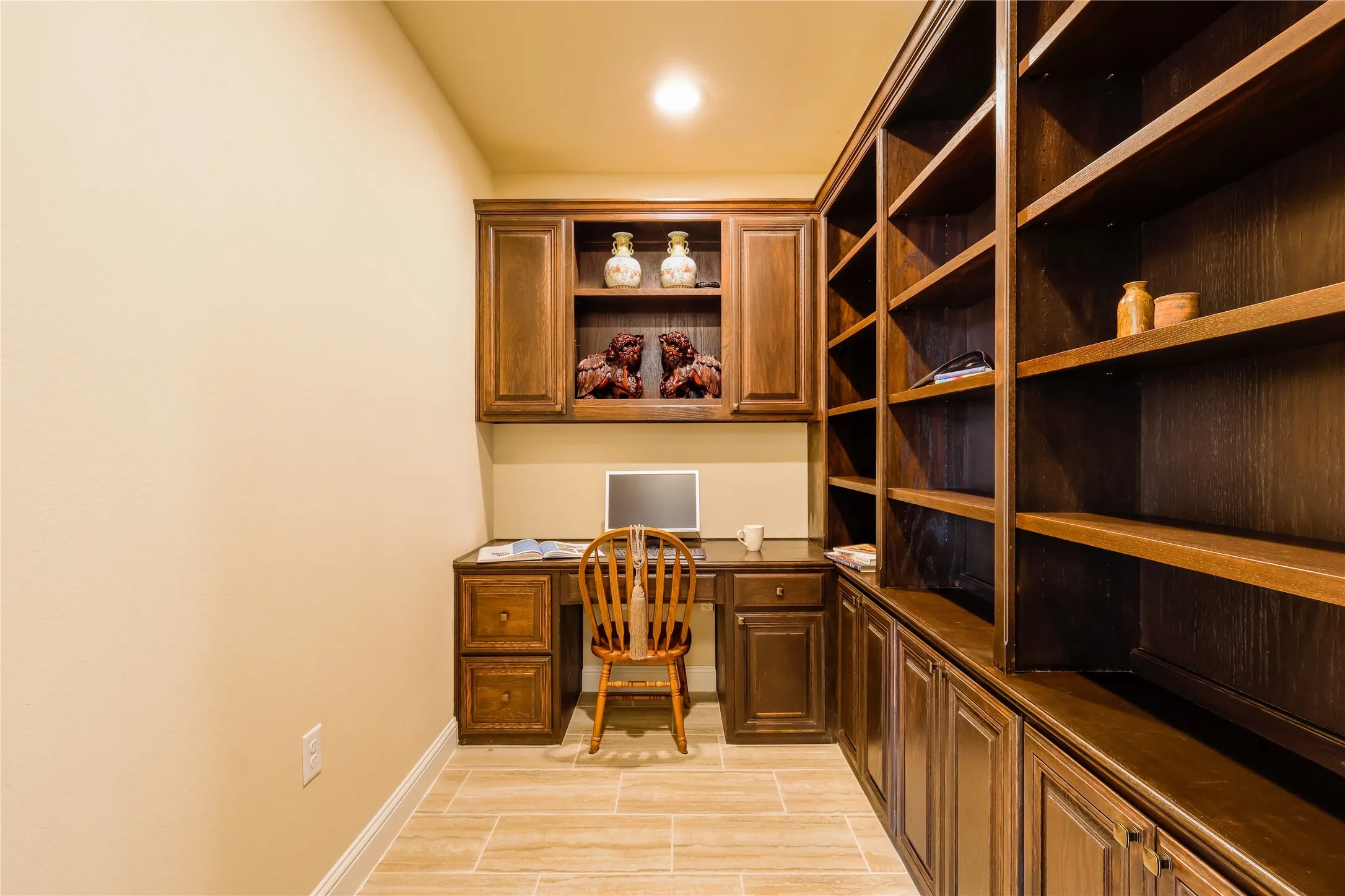 Built-in wood cabinetry and shelving define this space, complemented by light-toned wall paint and wood-finish flooring