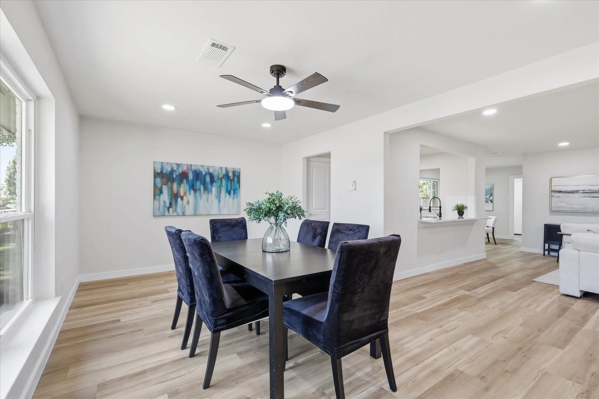 Dining area featuring wood-finish flooring, recessed lighting, and a ceiling fan