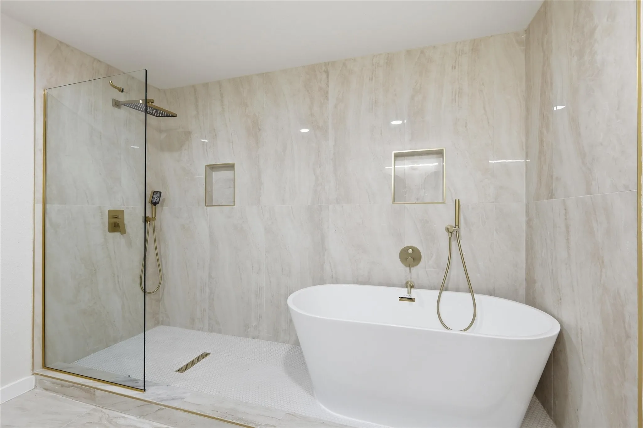 Freestanding soaking tub with gold-finish fixtures