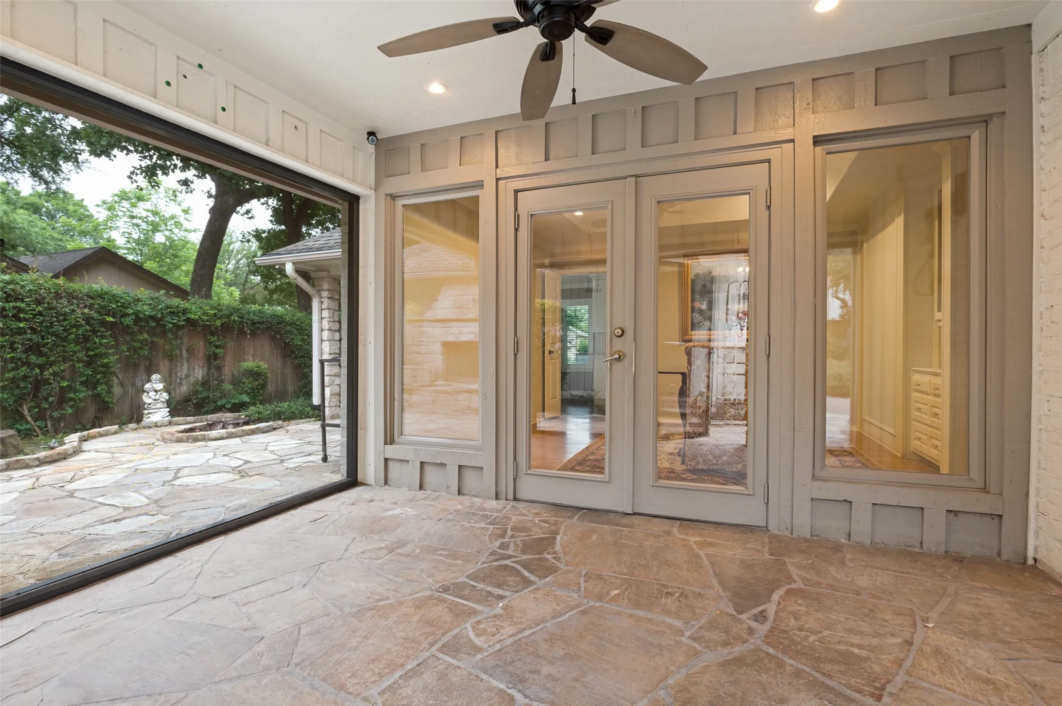 Covered patio featuring an irregular stone paver floor