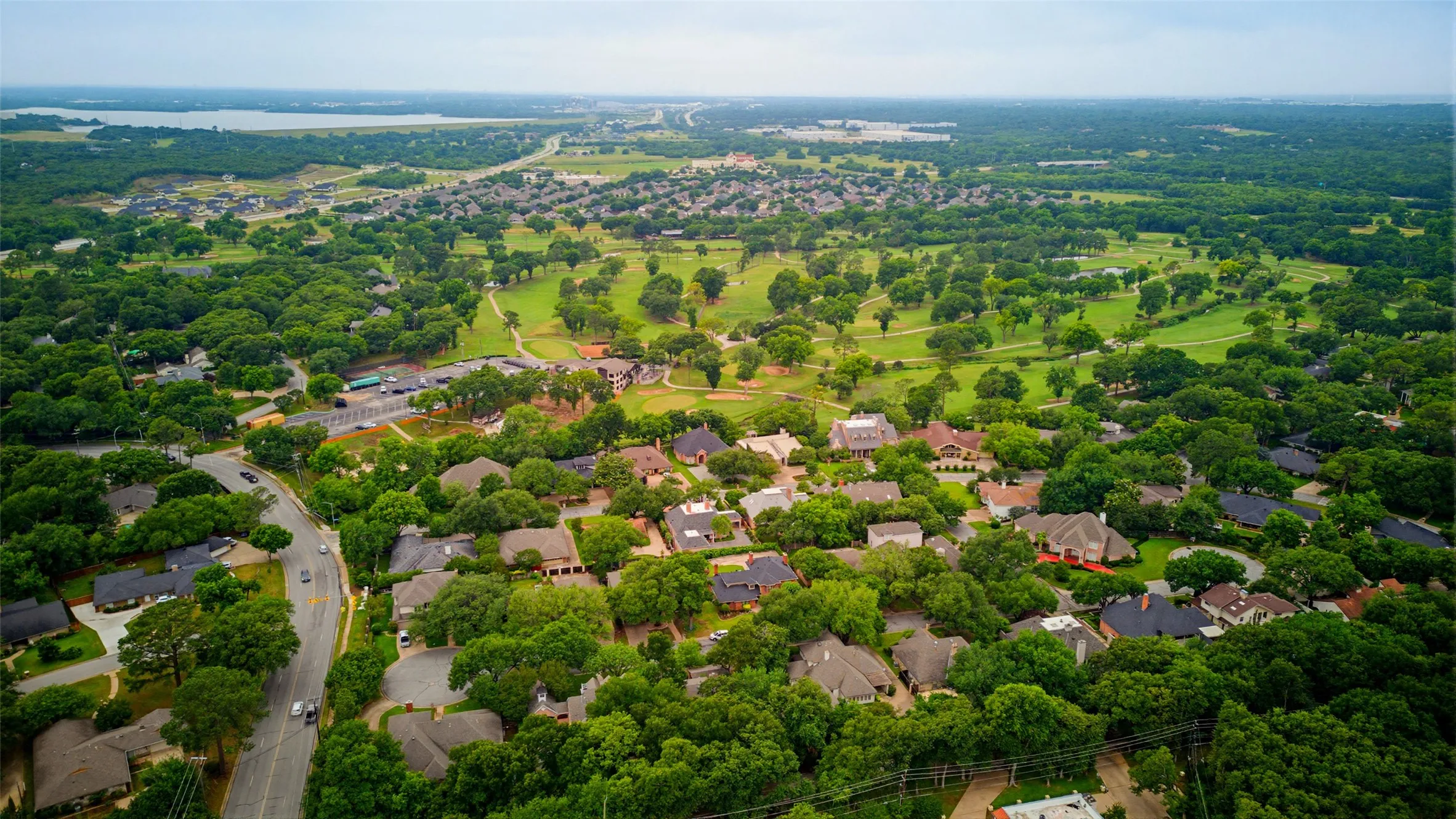 Aerial perspective showcasing a residential community with mature tree coverage