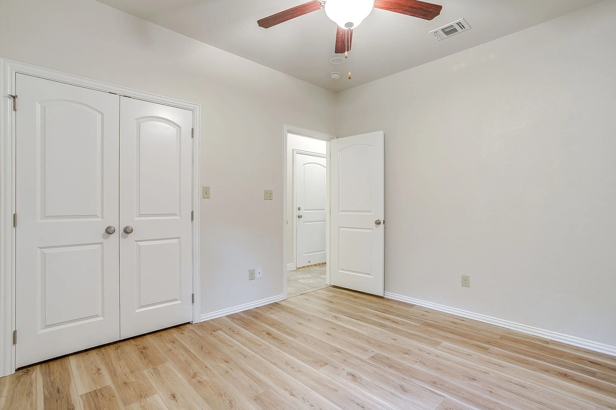 Secondary or guest bedroom with double door walk in closet