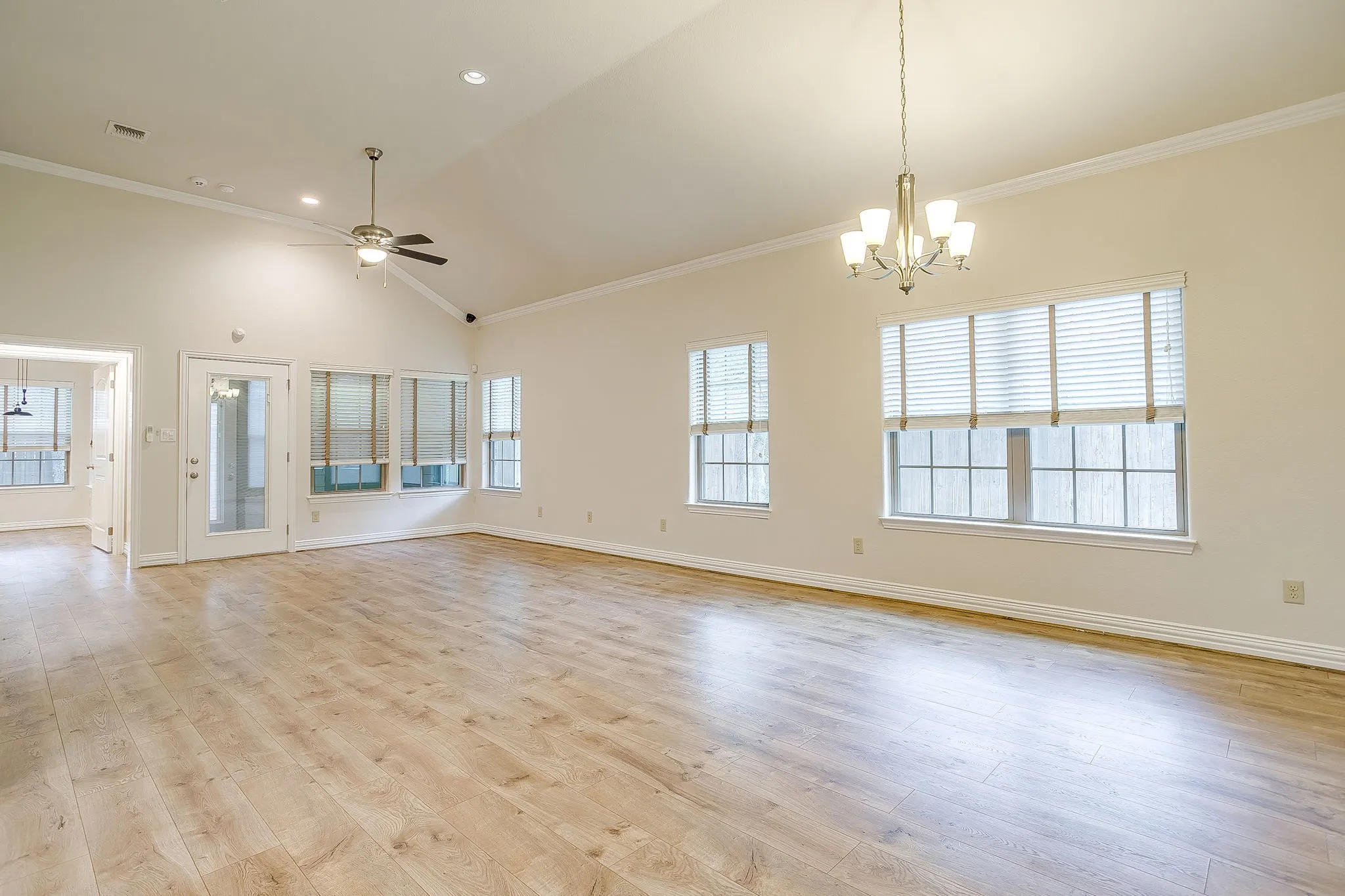 Extra large living/dining combo with custom light and ceiling fans. Luxury plank floors and a remote that operates all shades. Repainted top to bottom 2 weeks ago including molding and baseboards. Just move in!