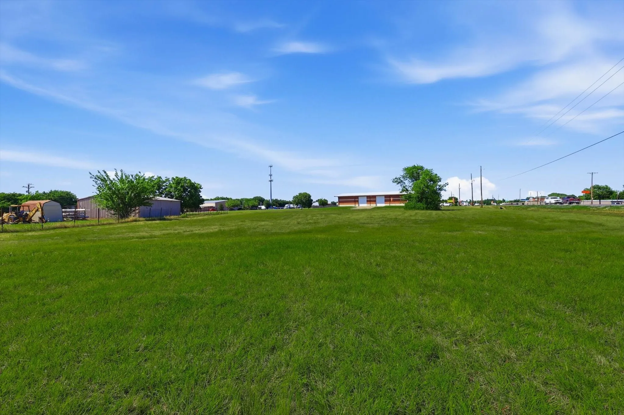 Expansive green field under a clear sky