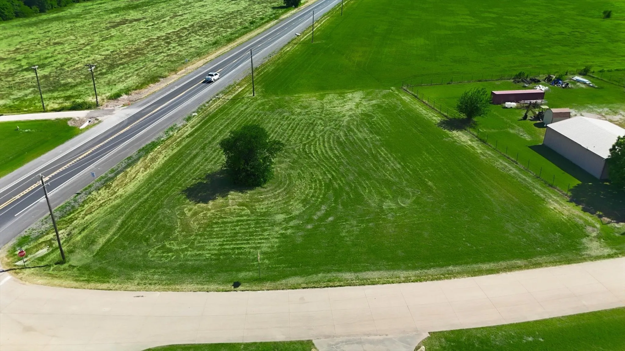 Expansive green parcel featuring a mature tree