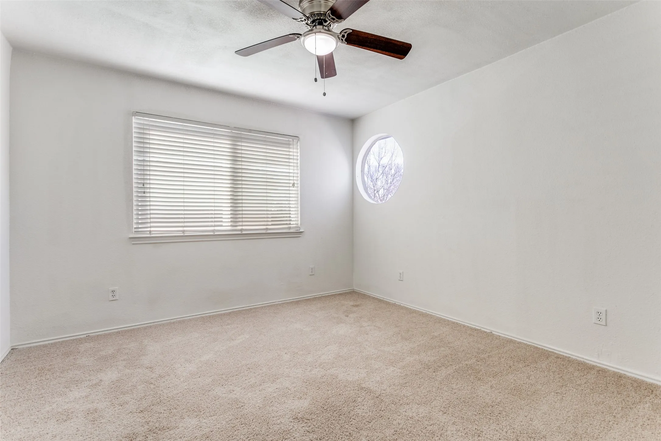 Spacious 2nd Primary Bedroom upstairs  bedroom featuring neutral carpet flooring, a ceiling fan with light fixture, and white wall finishes