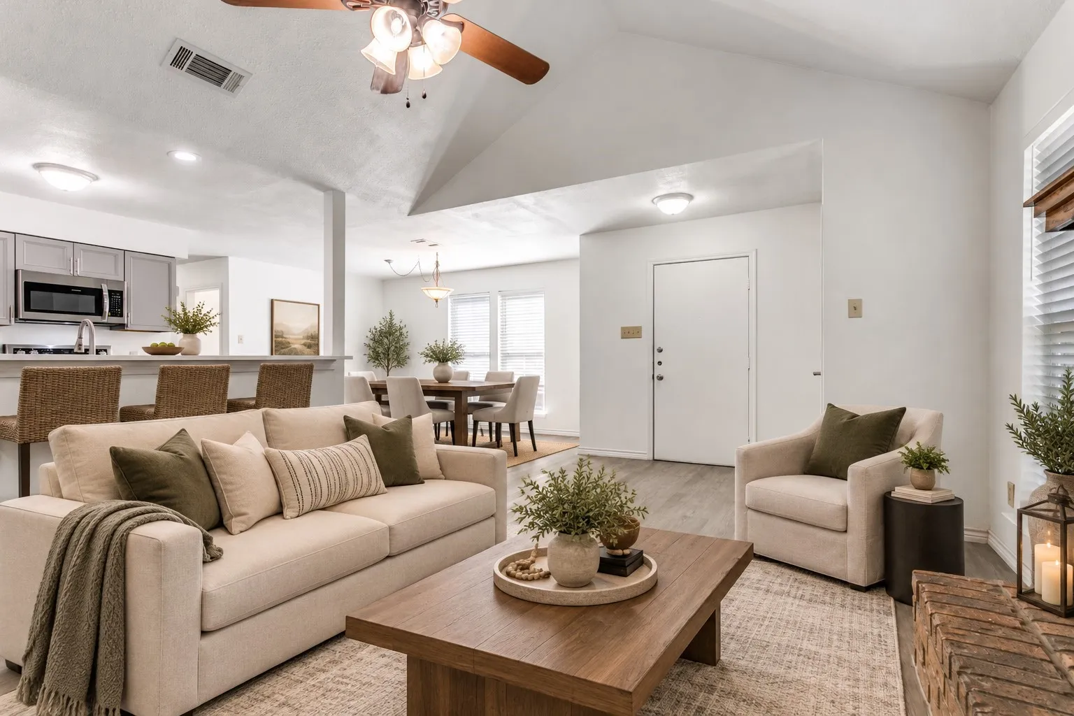 Vaulted ceilings, wood-finish flooring, and a ceiling fan with light fixture; Virtually Staged