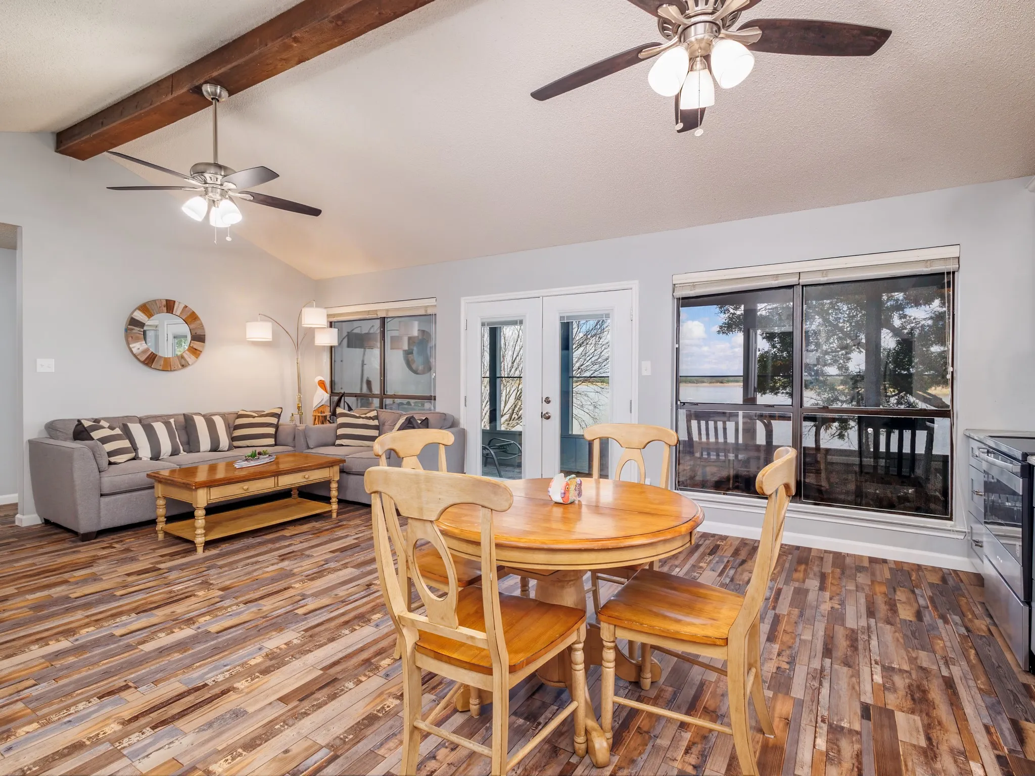 Open living room, dining room, and kitchen overlooking the lake.
