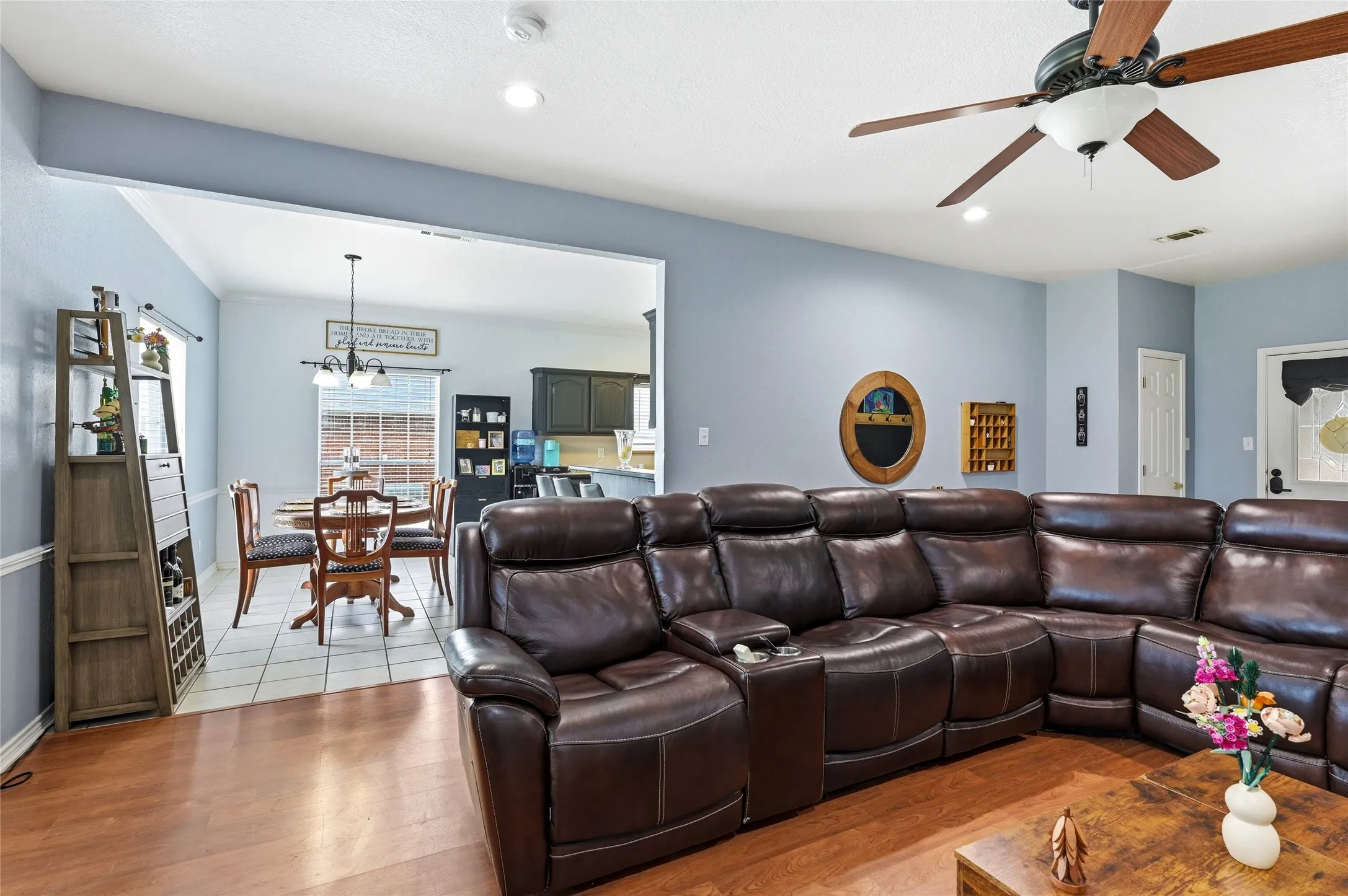 Open-concept living area featuring wood-finish flooring, a ceiling fan, and recessed lighting