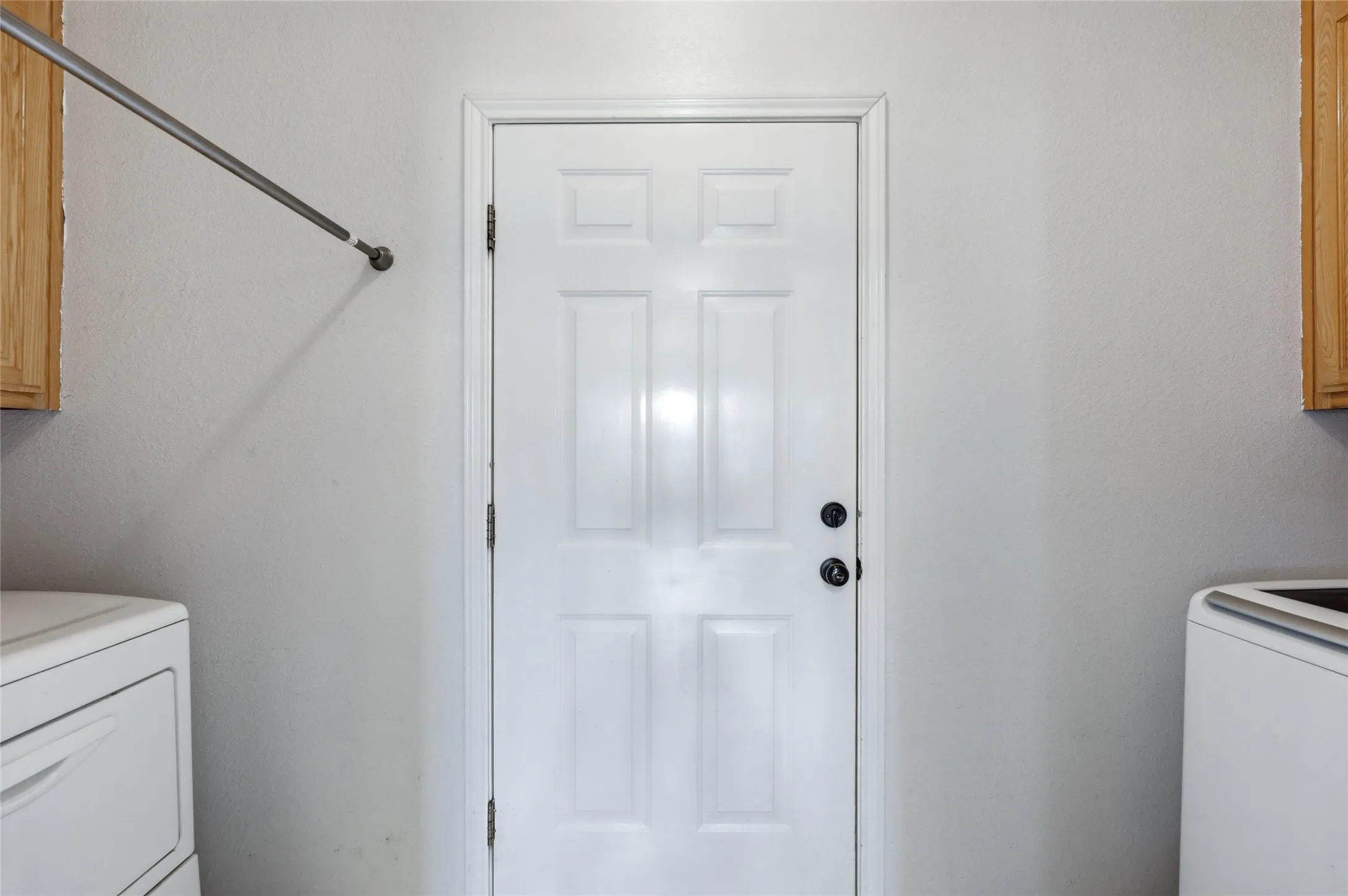White paneled door with black hardware
