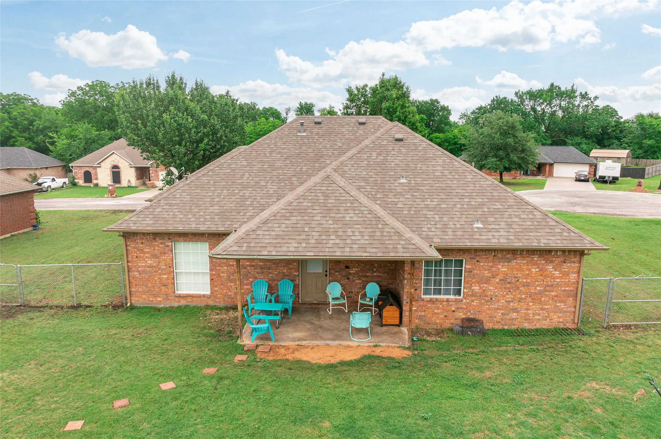 Brick exterior featuring a gabled roofline and covered patio