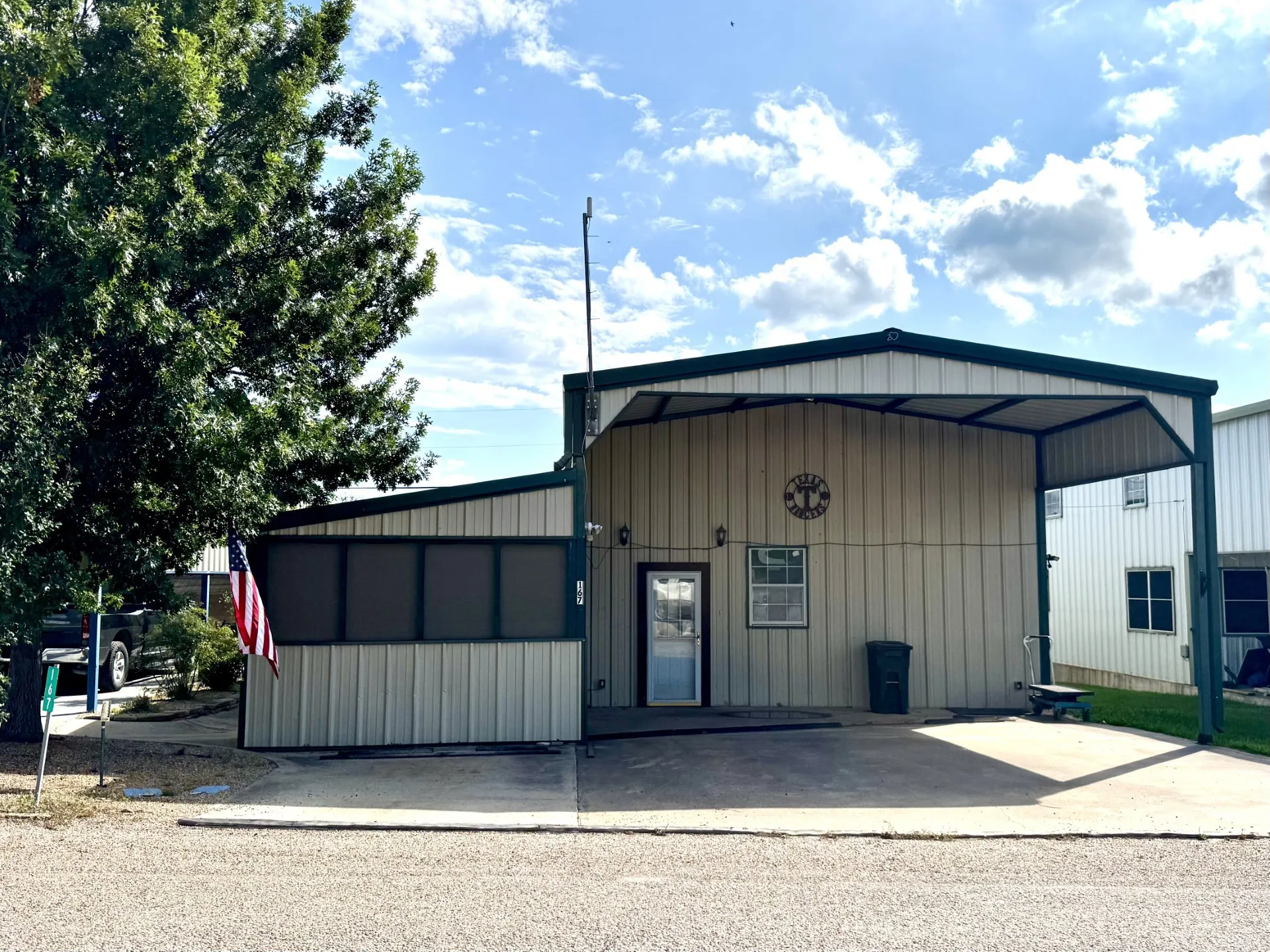 Metal Home featuring CARPORT and an attached Screened-in Patio... Parking for 3 Vehicles