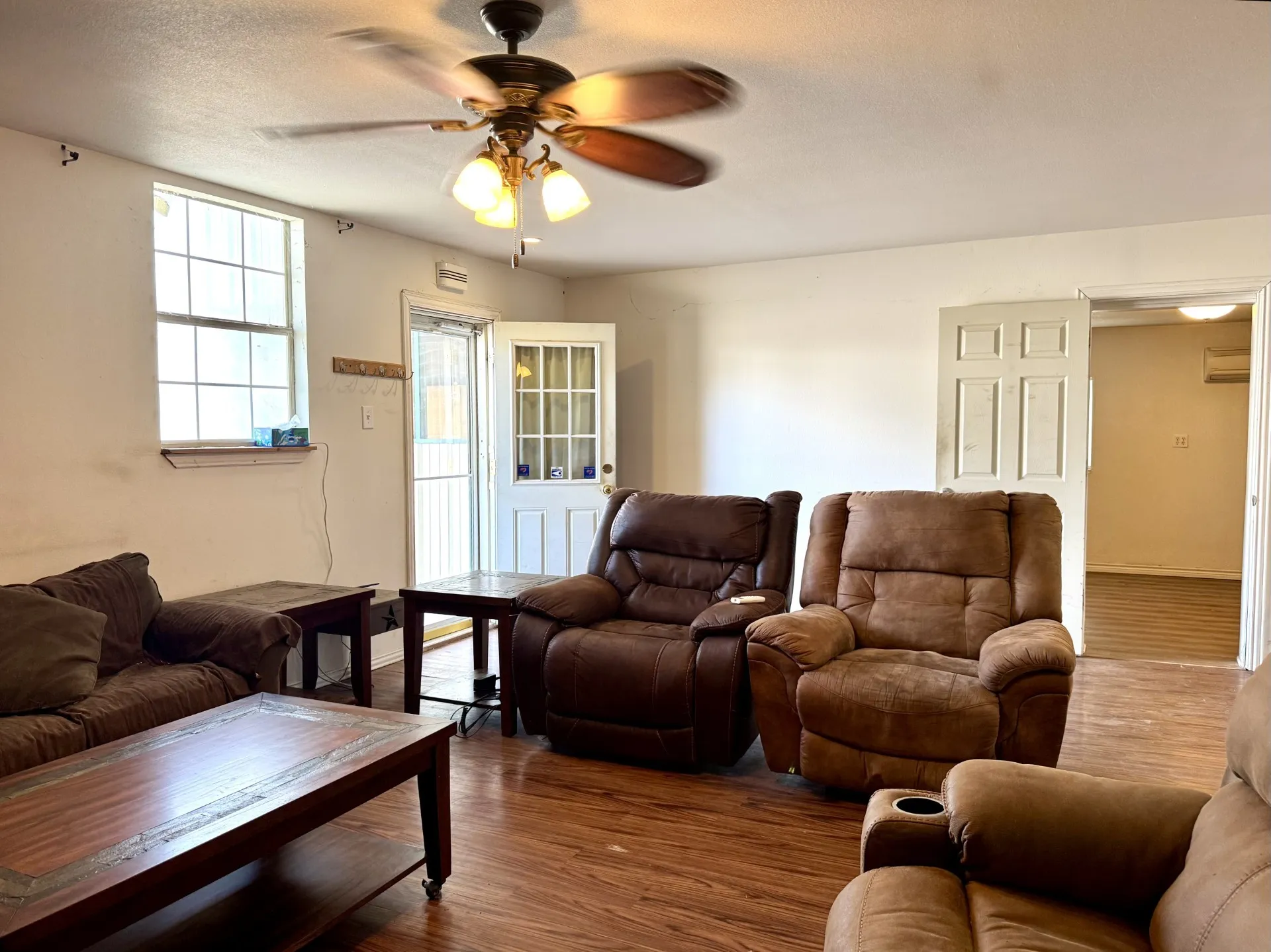 Front Living Room: wood-finish flooring and ceiling fan... OPENS to 2nd Bedroom