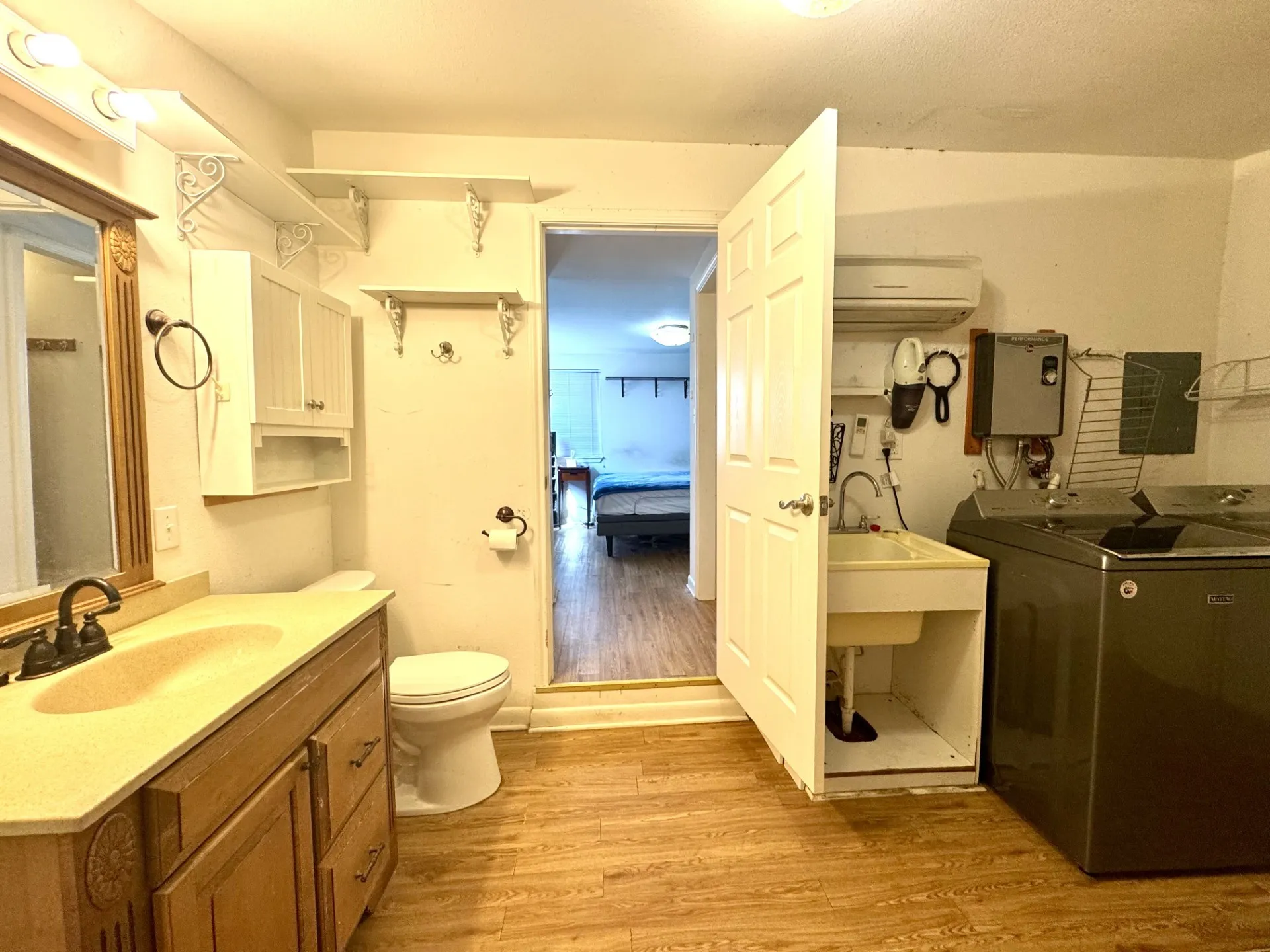 Primary Bath OPENS to Laundry and Workshop