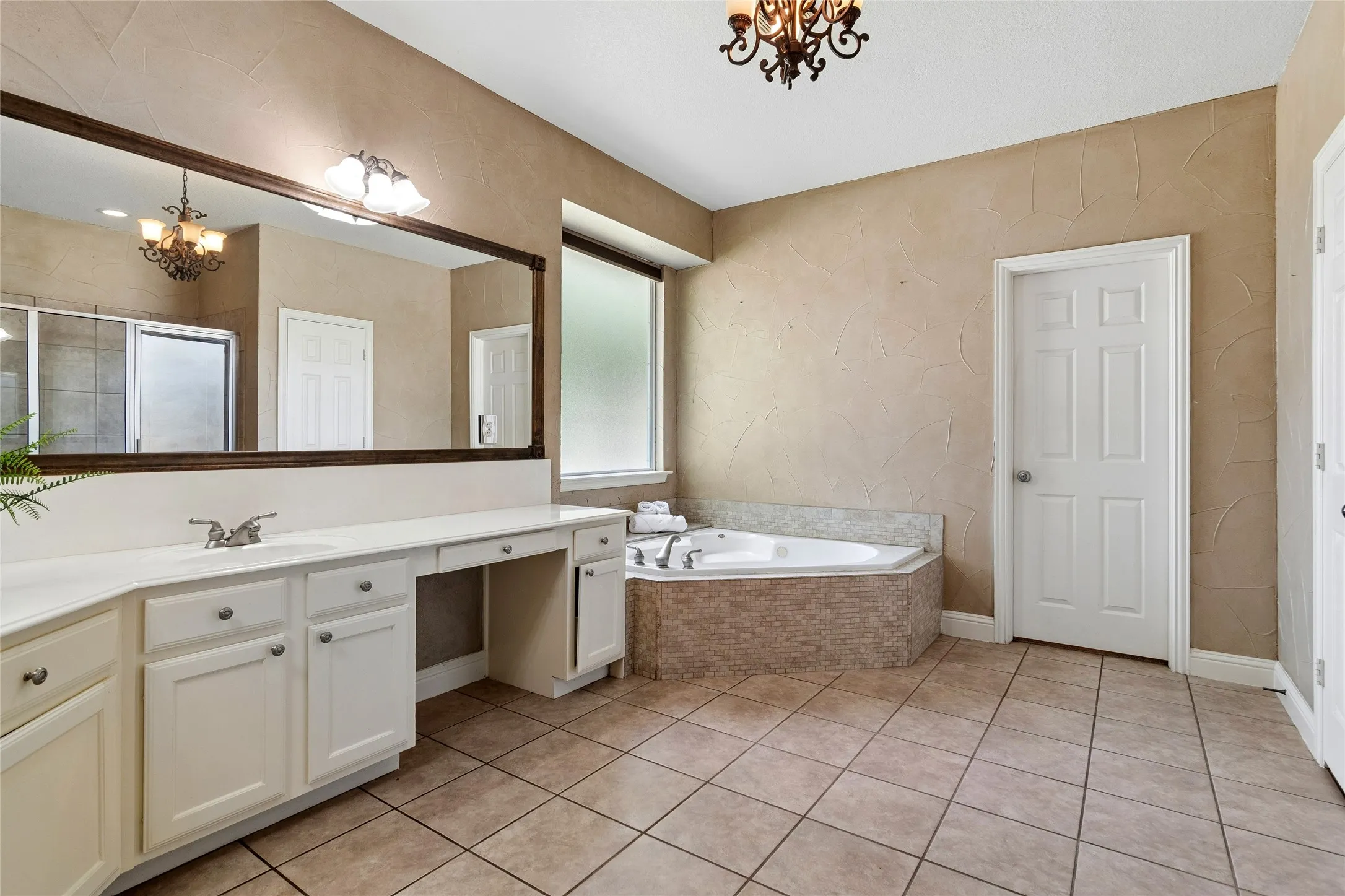 Primary bathroom, with jetted tub, separate vanities, walk in closet