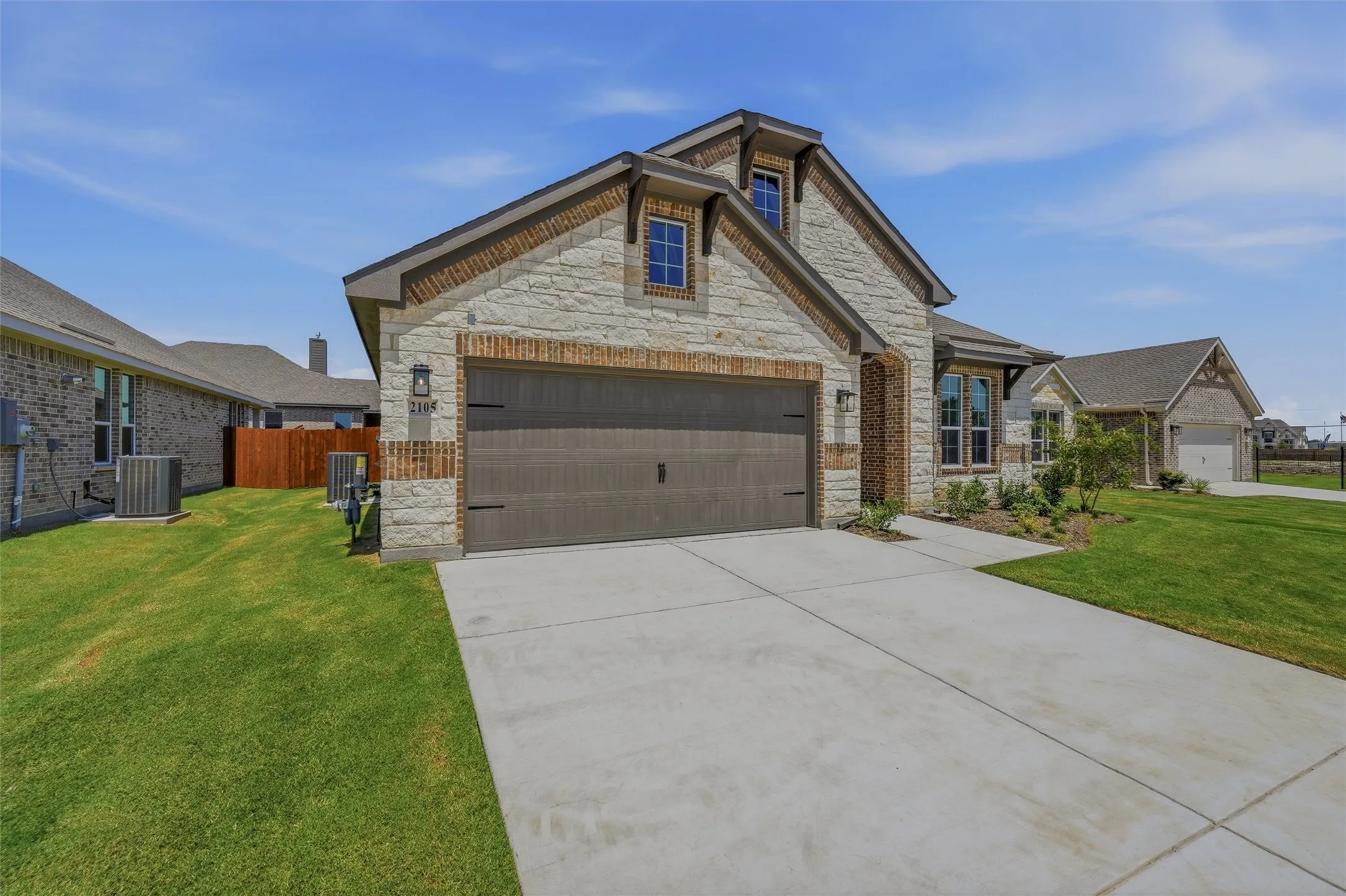 Stone and brick facade with a two-car garage