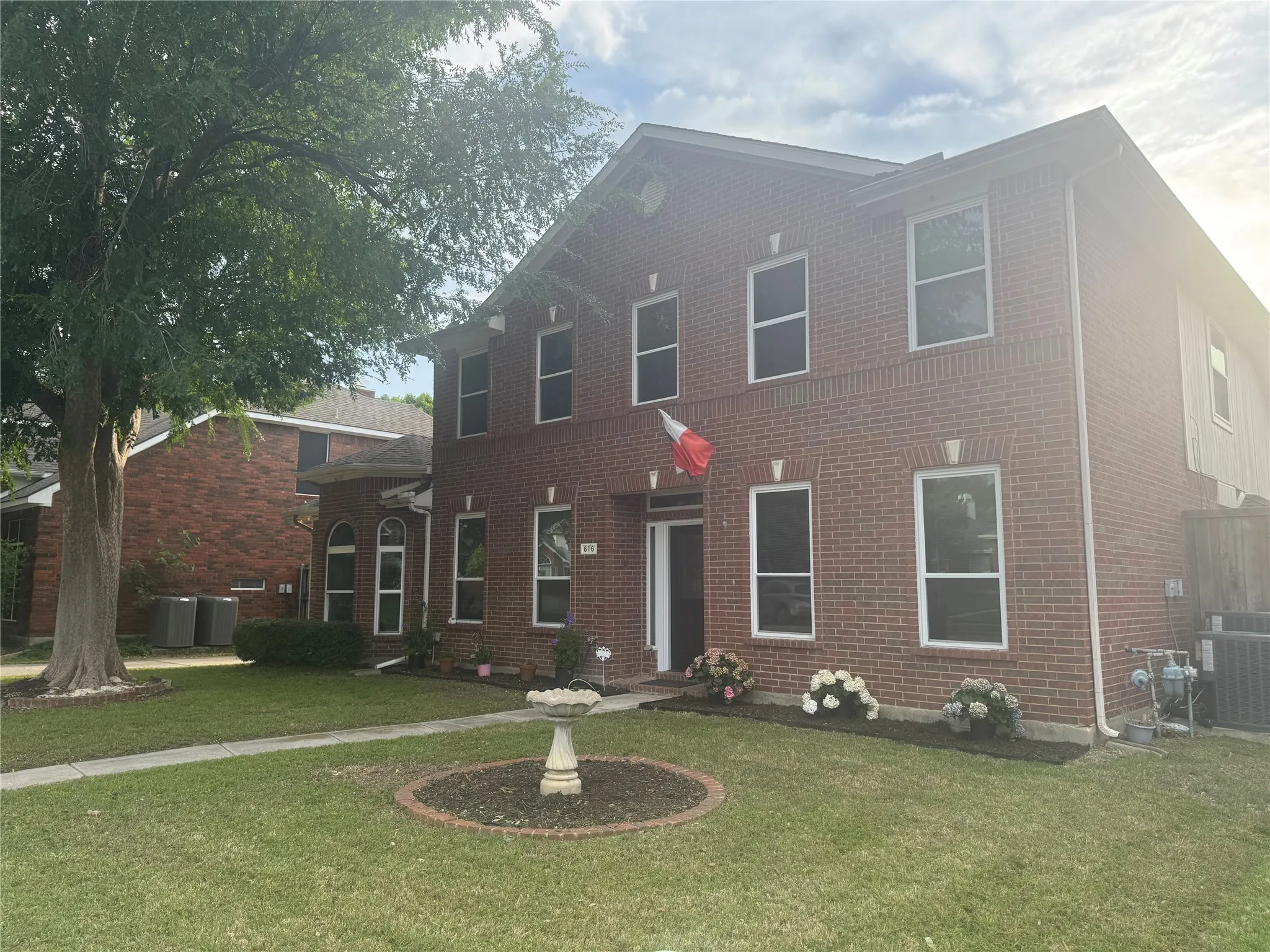 Traditional brick exterior with white trim windows and a prominent front entry