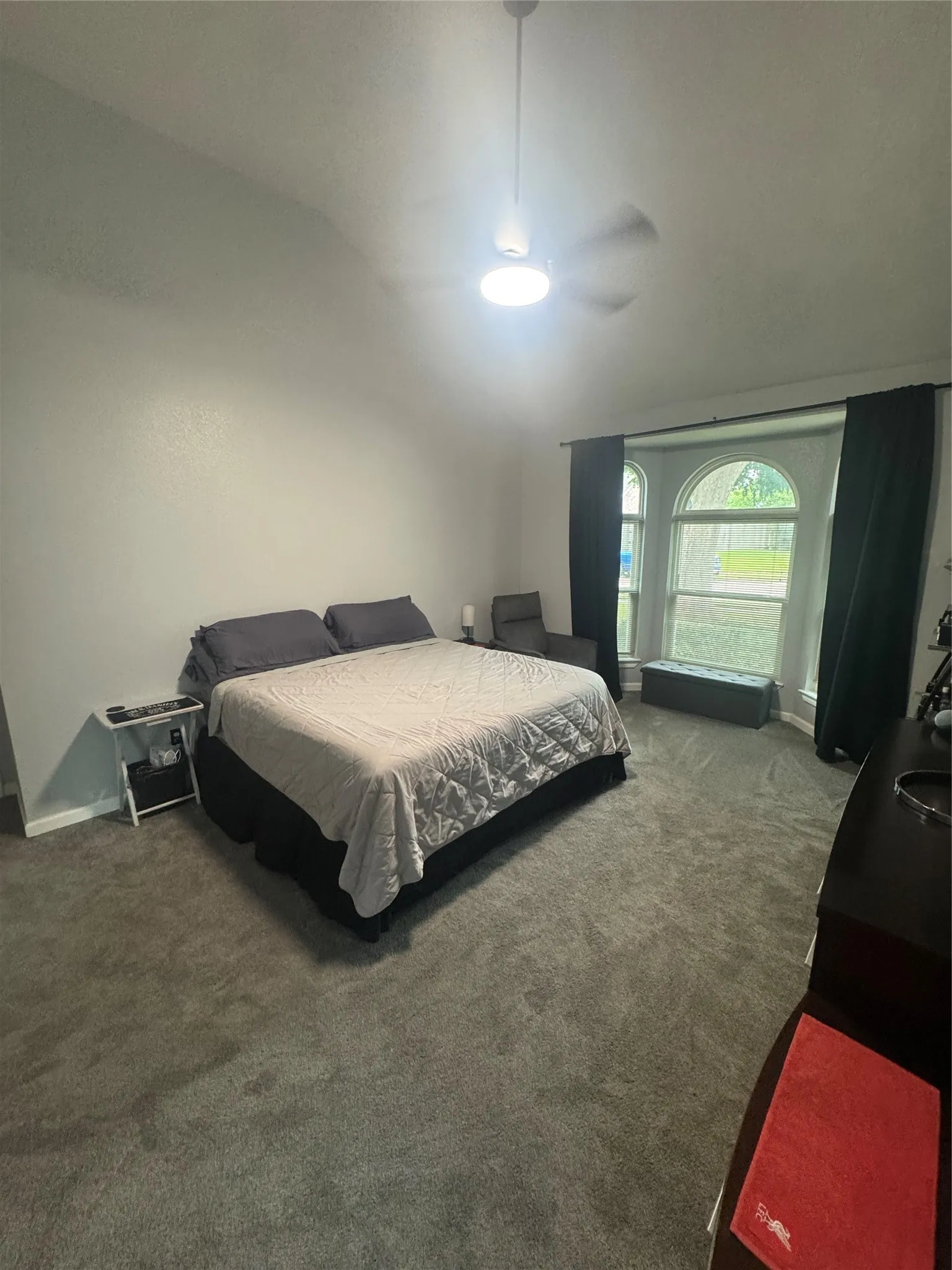 Bedroom featuring a vaulted ceiling and a ceiling fan with integrated lighting