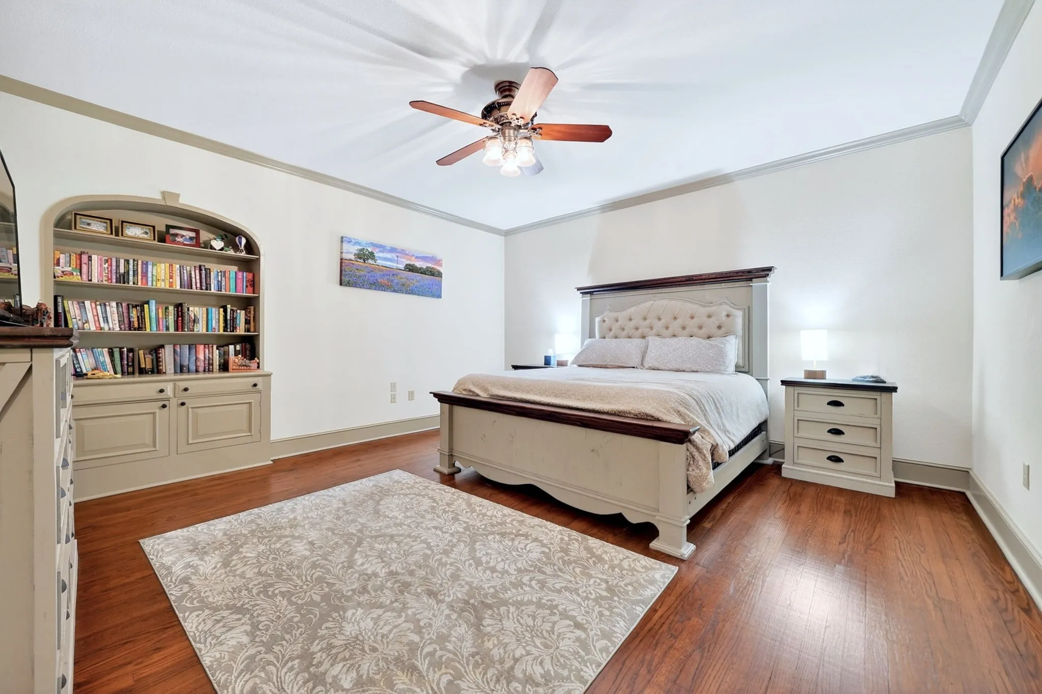 Hardwood-finish flooring, built-in shelving, crown molding, ceiling fan, and ample wall space