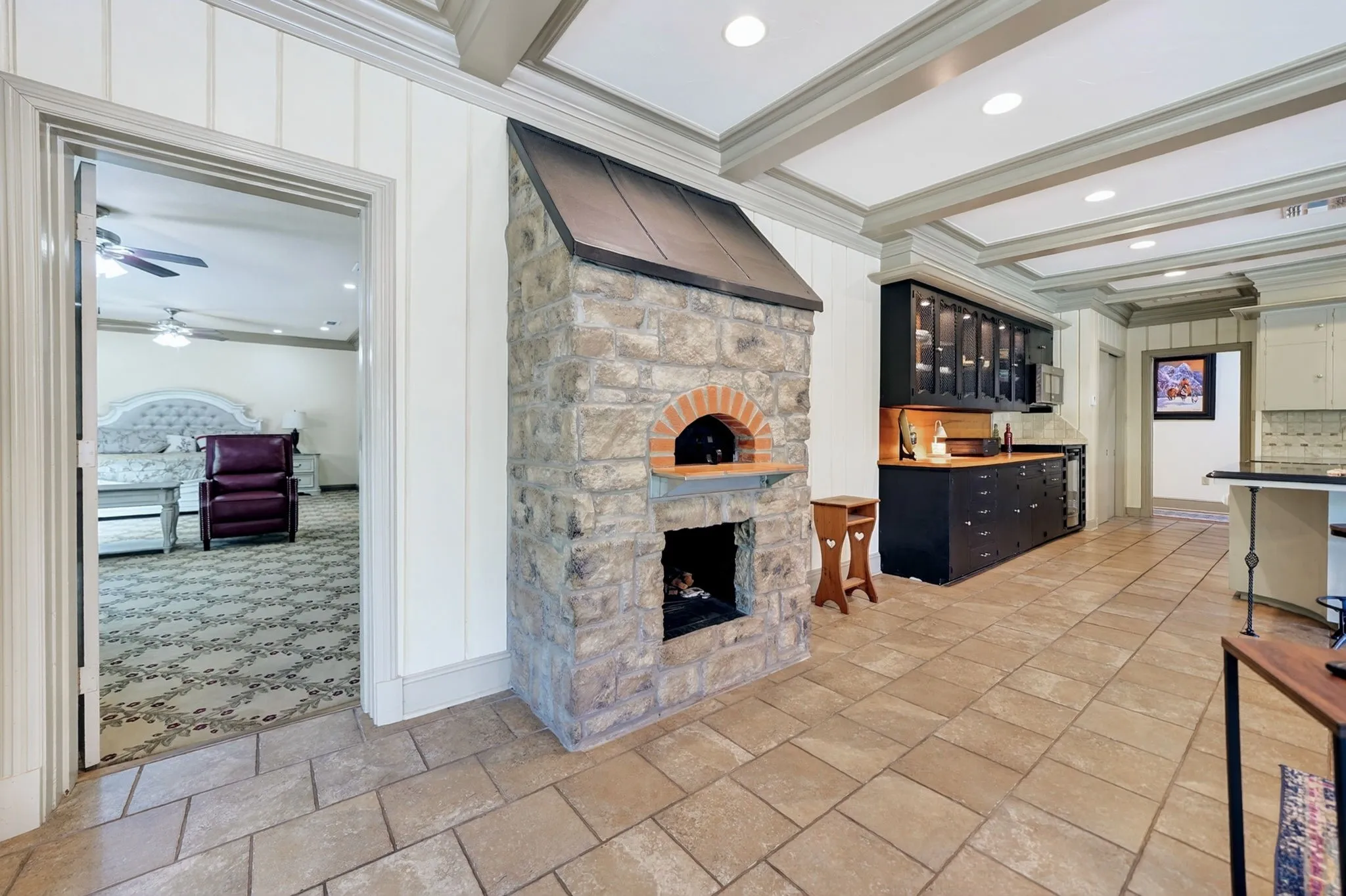 Stone-clad pizza oven with an arched brick opening