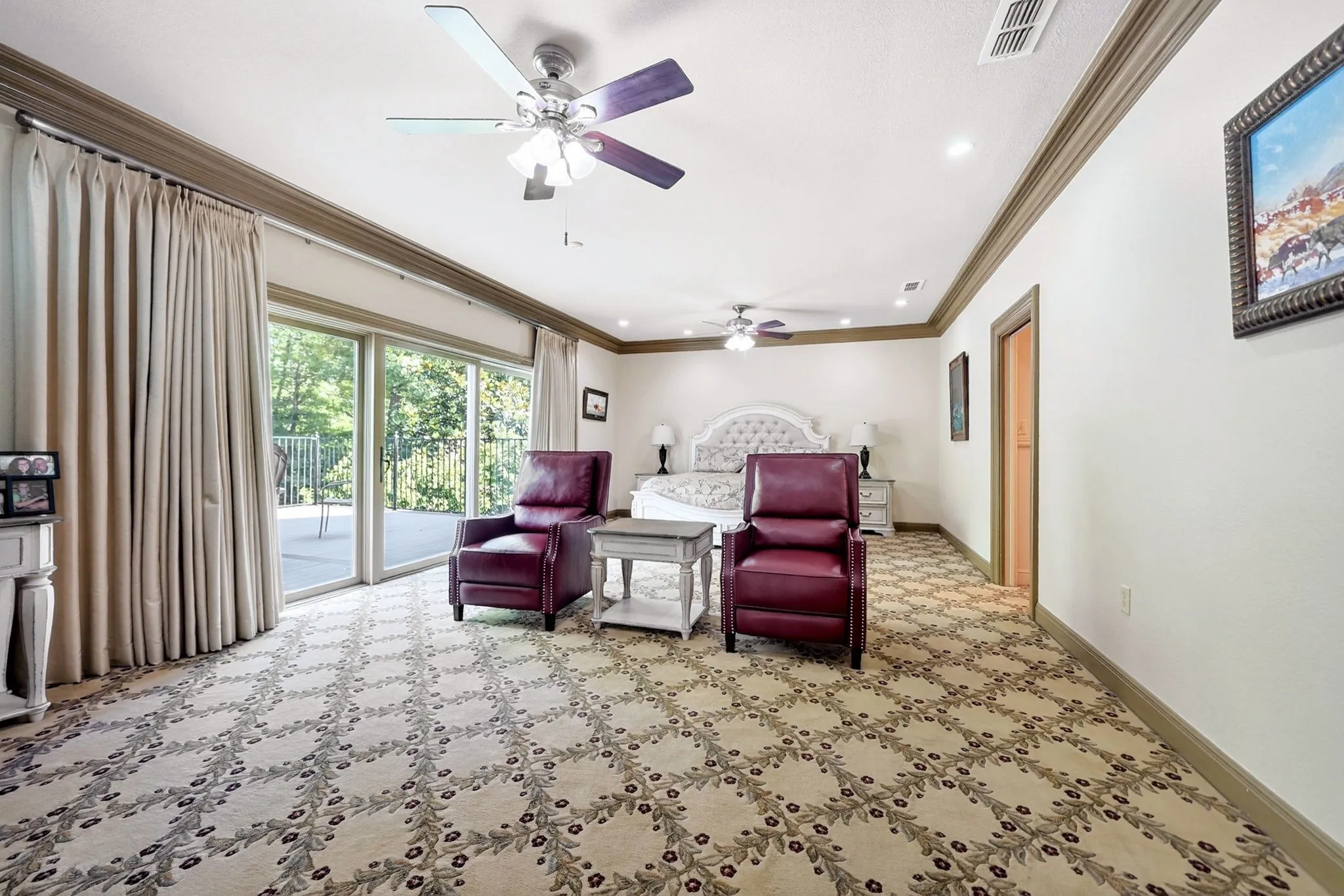 Spacious room featuring patterned carpeting and crown molding