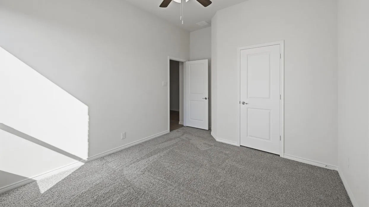 Neutral-toned room featuring light gray carpeting and white walls