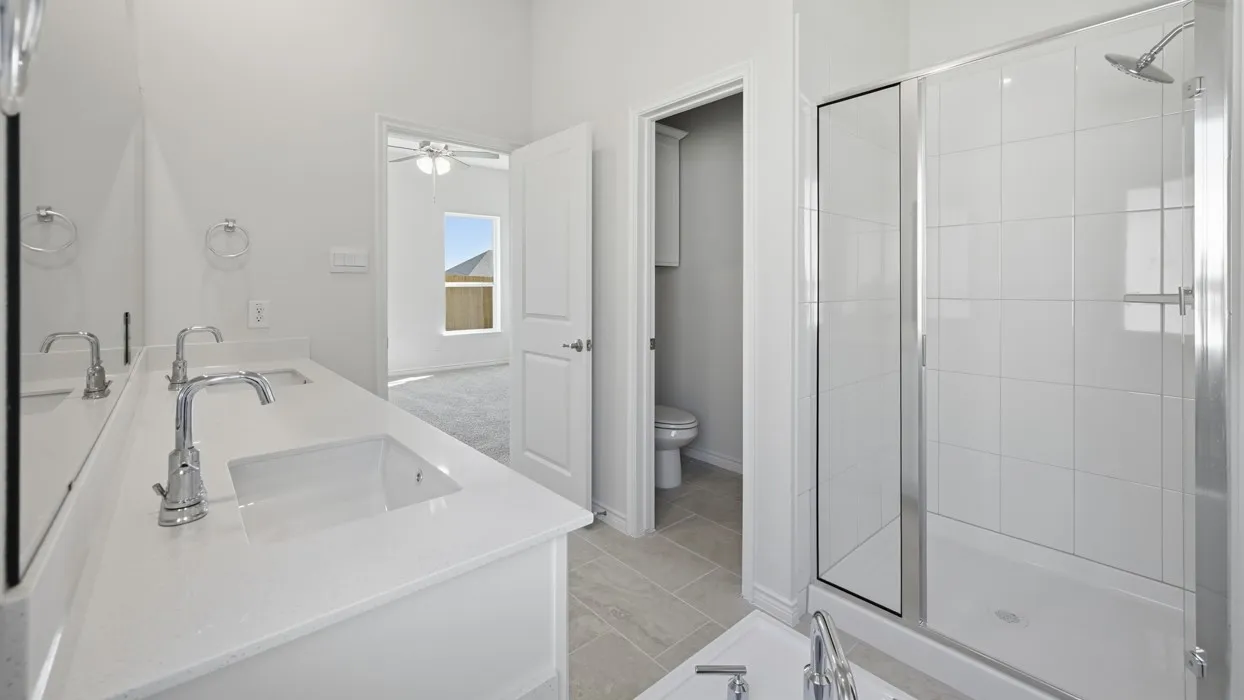 Double vanity with integrated sinks, chrome faucets, and a white countertop