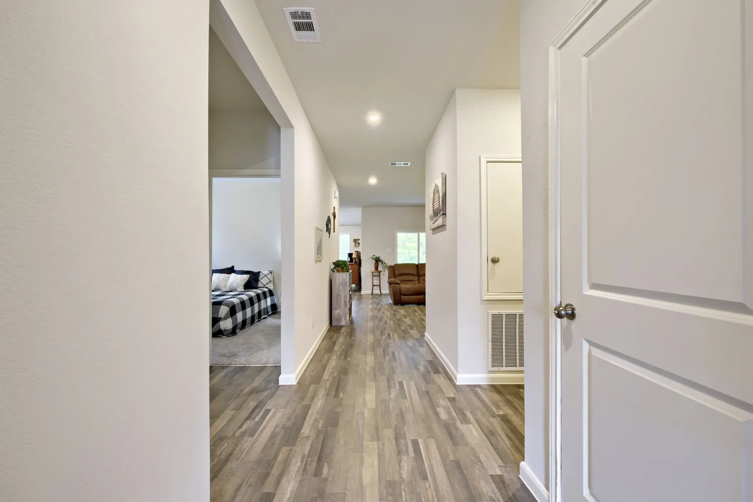 Hallway featuring wood-finish flooring and recessed lighting