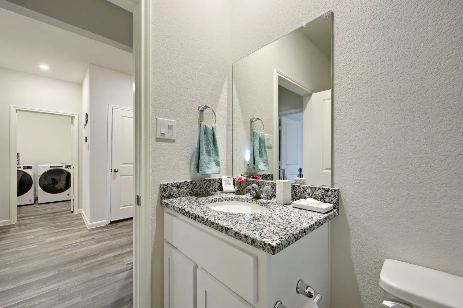 Bathroom vanity with a granite-style countertop and an undermount sink