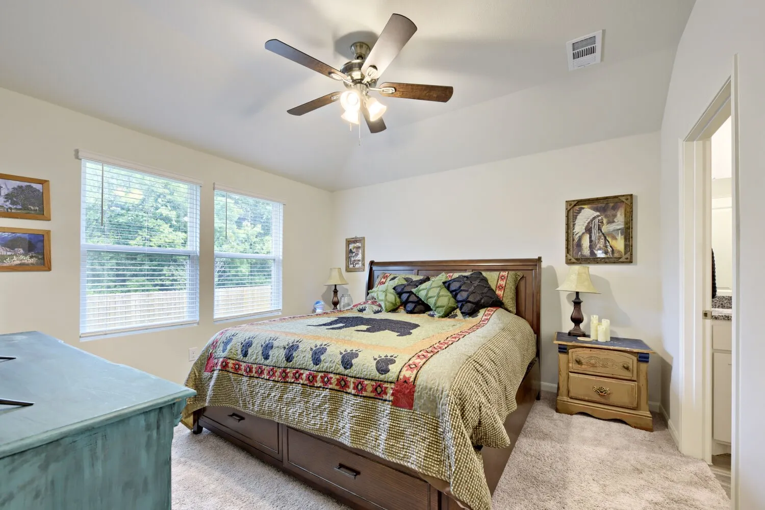 Bedroom featuring a vaulted ceiling, twin windows, a ceiling fan with integrated lighting, and carpet flooring