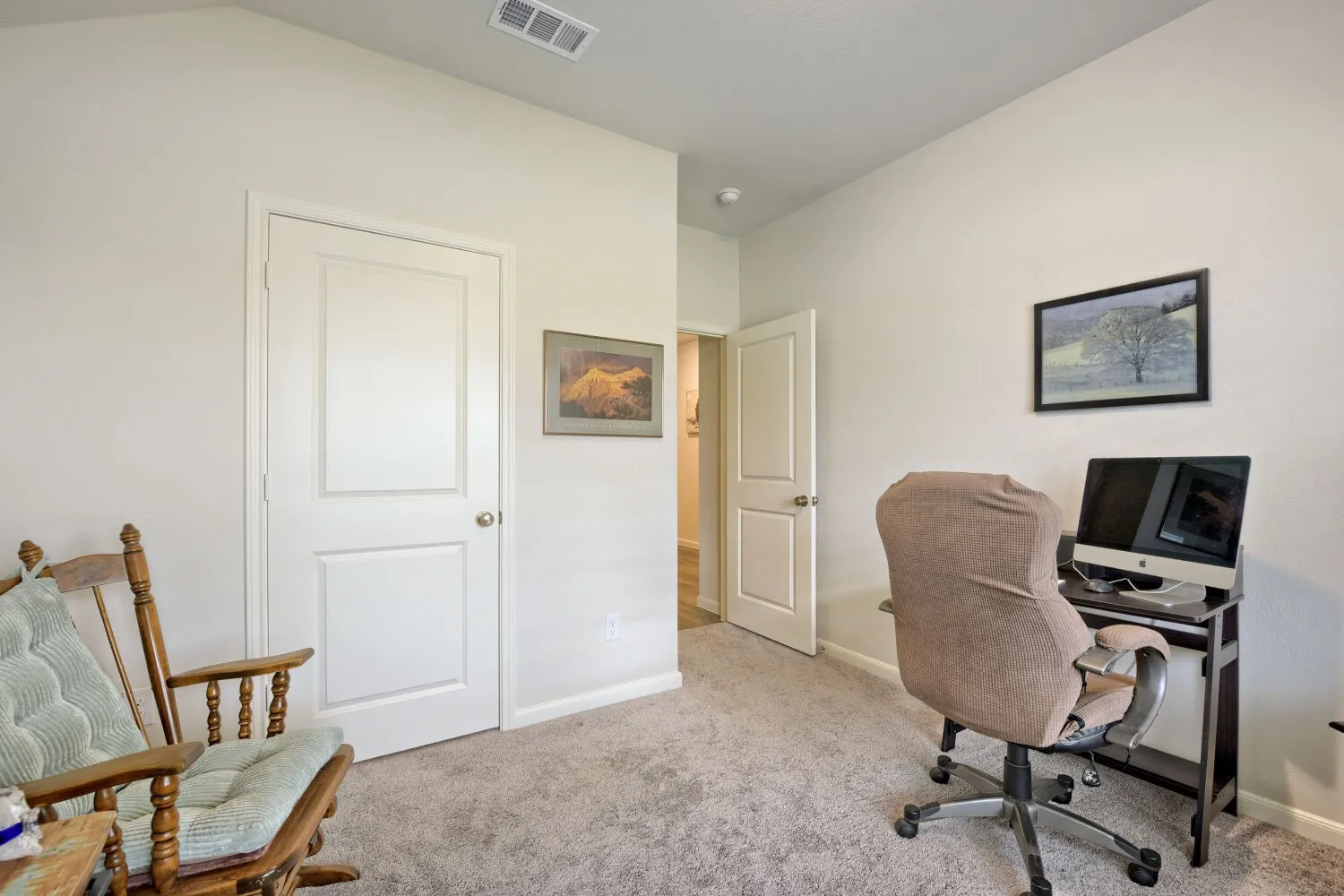 Versatile room featuring light-toned walls, gray carpet flooring, and white panel doors
