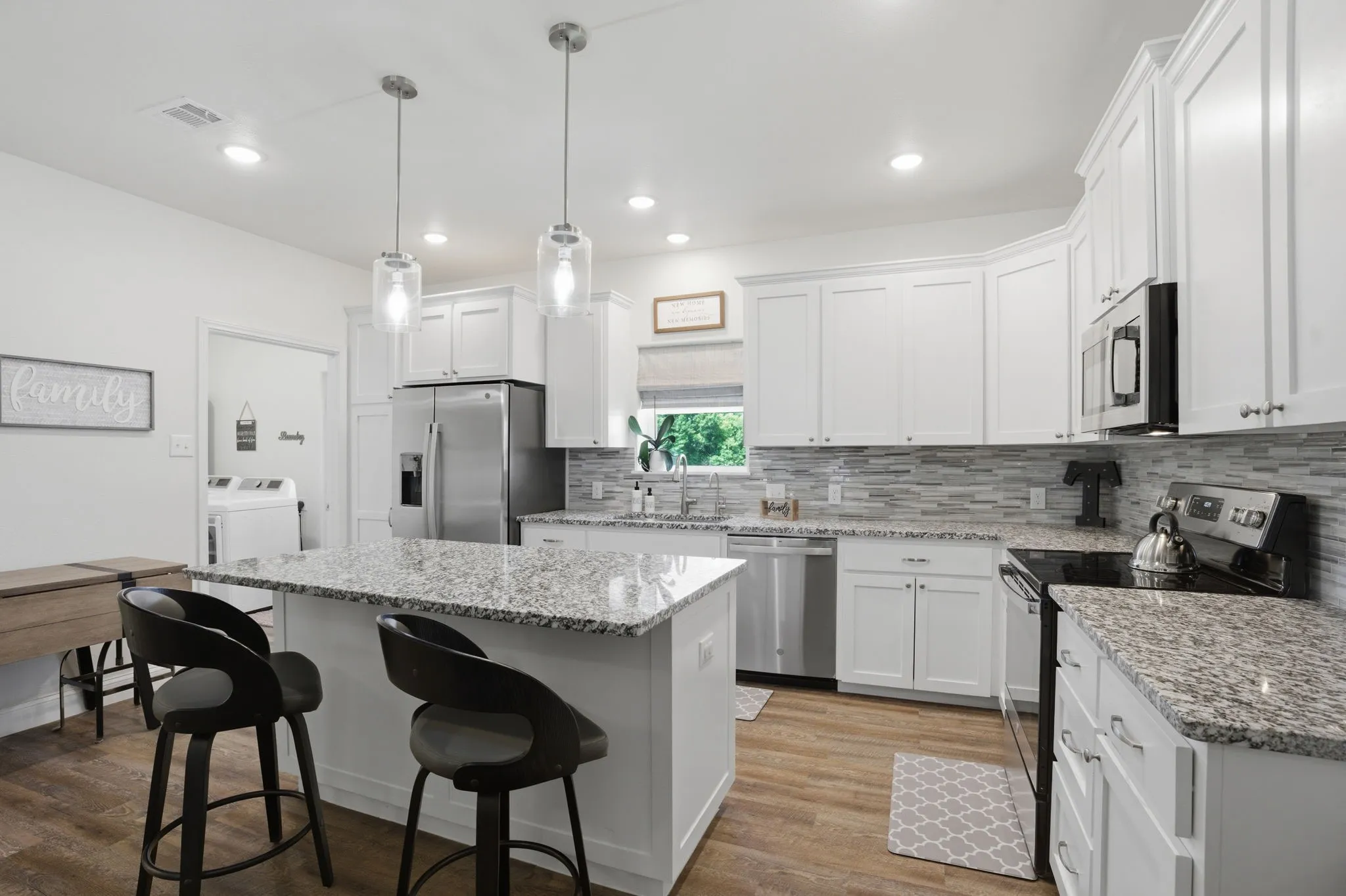 Kitchen (16X12) with extensive crisp white shaker cabinets, a large island and gorgeous granite countertops!