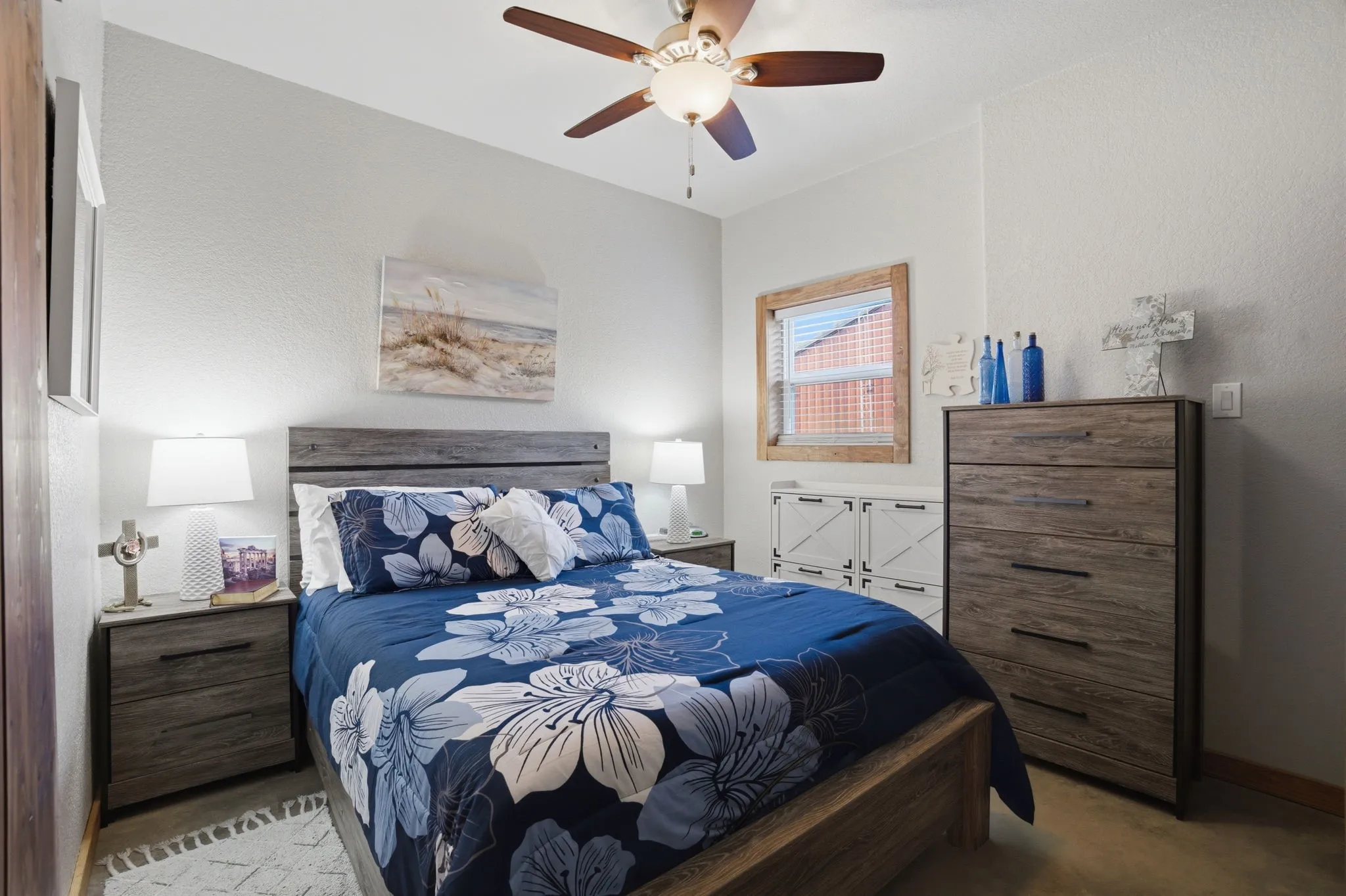 The bedroom is 12X10 and is shown with a queen size bed, nightstands, dresser and chest of drawers