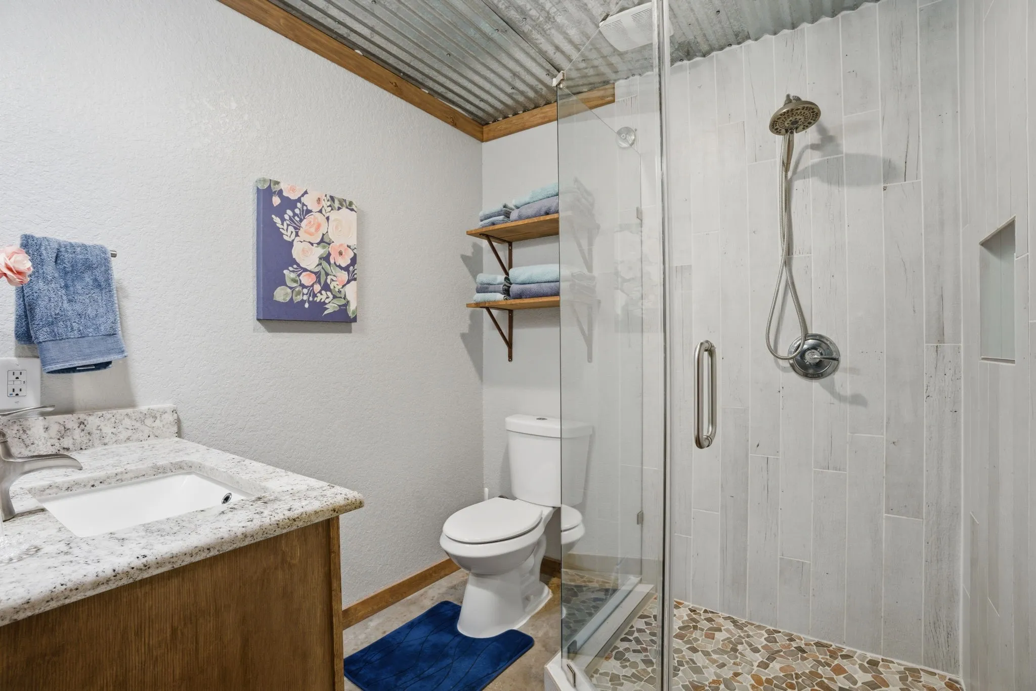 Stylish bathroom with frameless glass and shampoo niche. Tankless water heater.