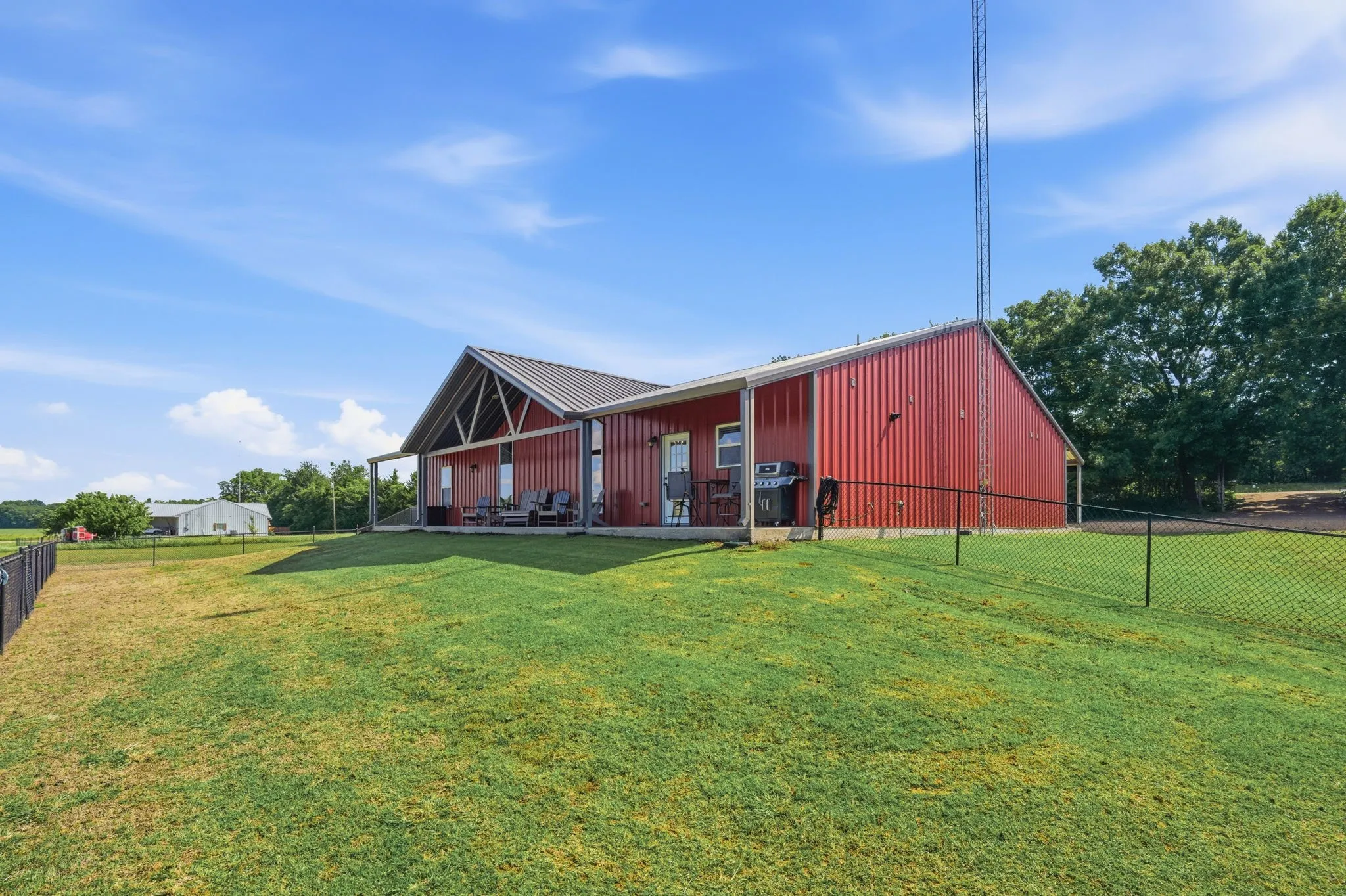 Expansive back porch with fantastic views of the property and fenced yard.