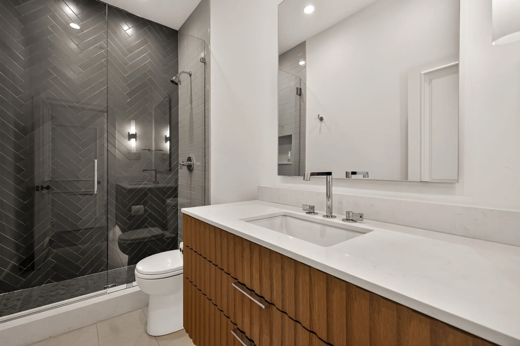 Vanity featuring a white countertop with an undermount sink and chrome faucet