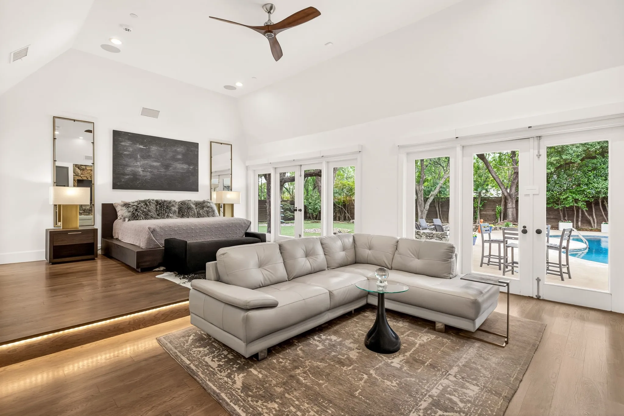 Vaulted ceiling with a contemporary ceiling fan and recessed lighting