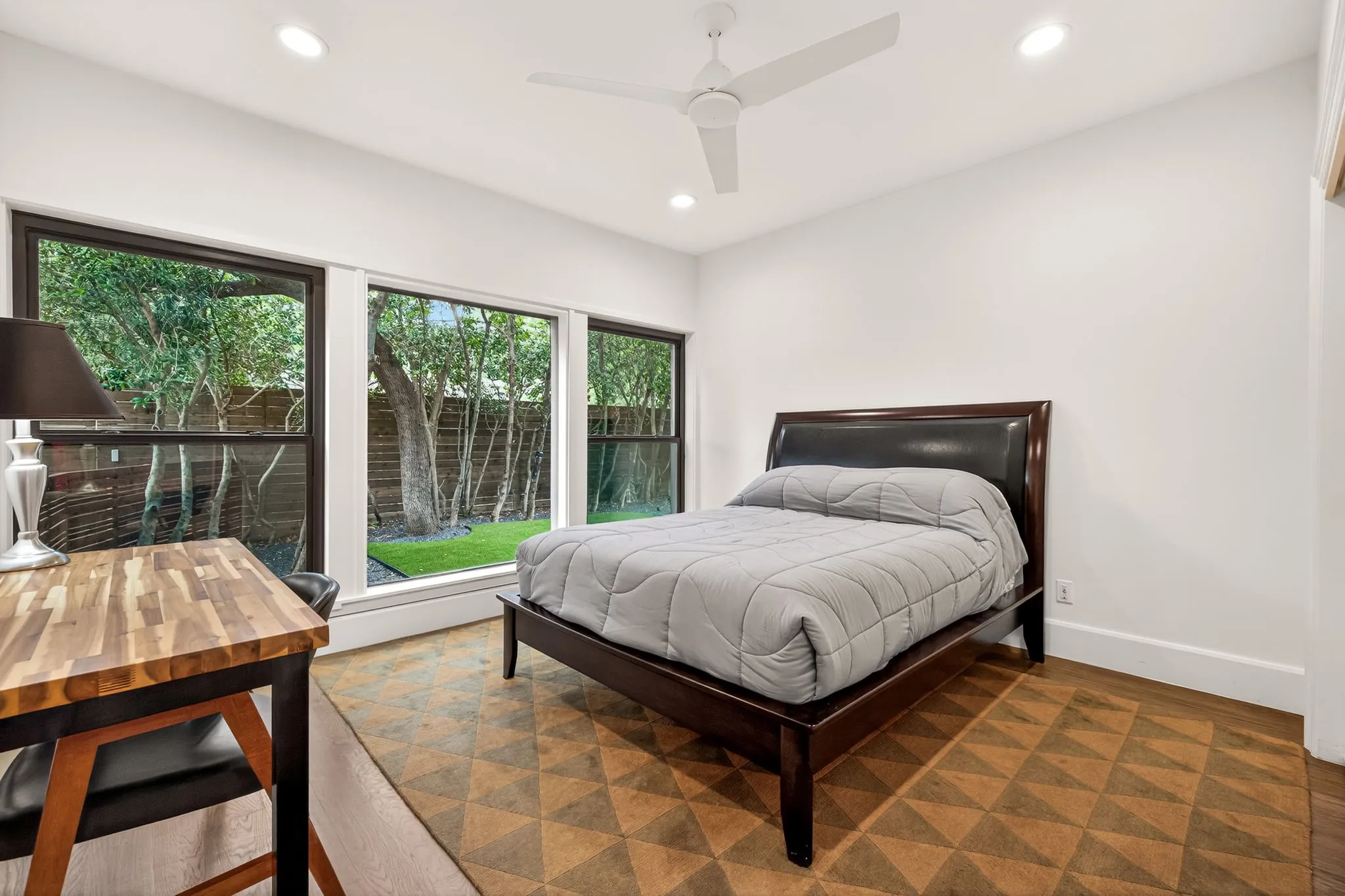 Bright interior featuring recessed lighting, a ceiling fan, and expansive windows