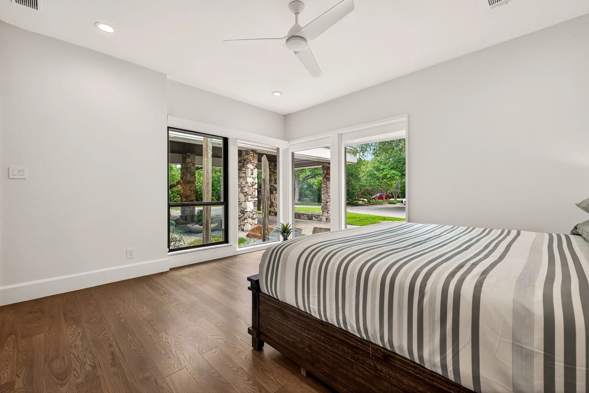 Room featuring wood-finish flooring, recessed lighting, and a ceiling fan