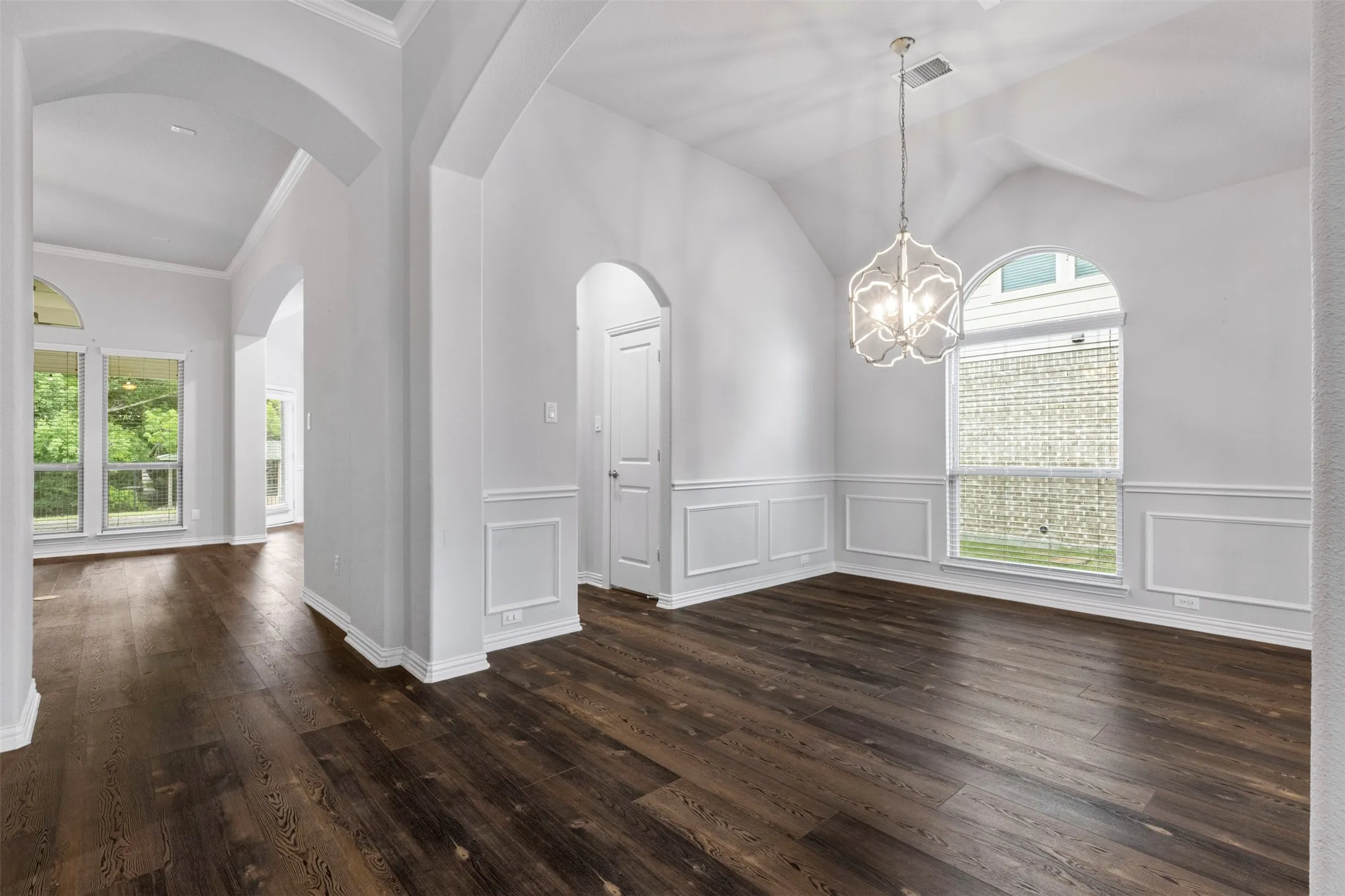 Entry way looking at the tall ceilings in the formal dining all the way through to backyard