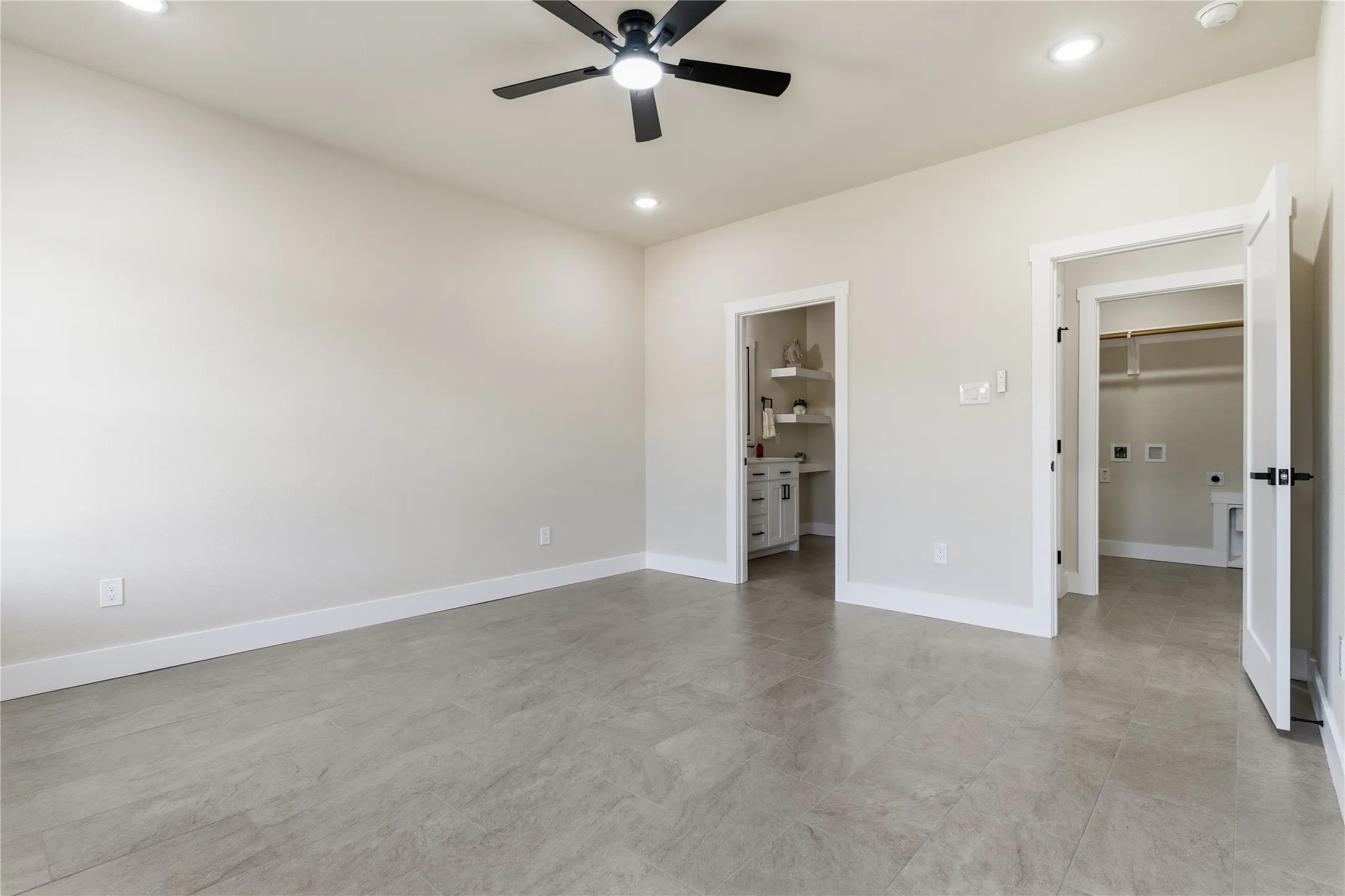 Recessed lighting, ceiling fan, tile flooring, laundry hookups, and a built-in vanity with open shelving