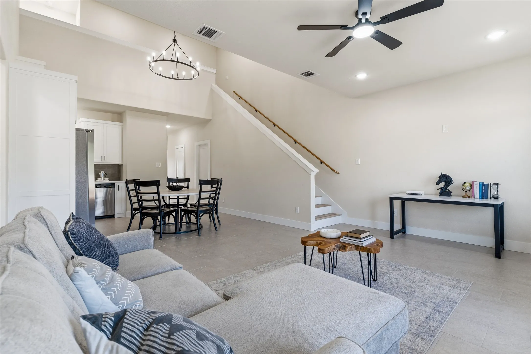 Vaulted ceiling with an industrial-style chandelier and recessed lighting