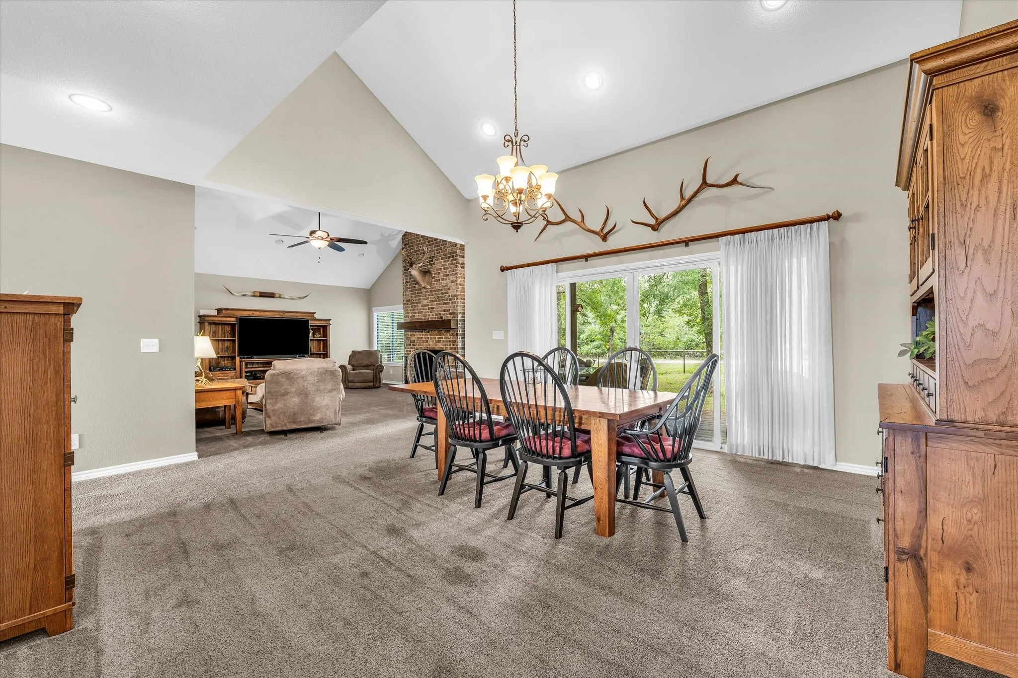 Spacious dining area with vaulted ceilings and recessed lighting