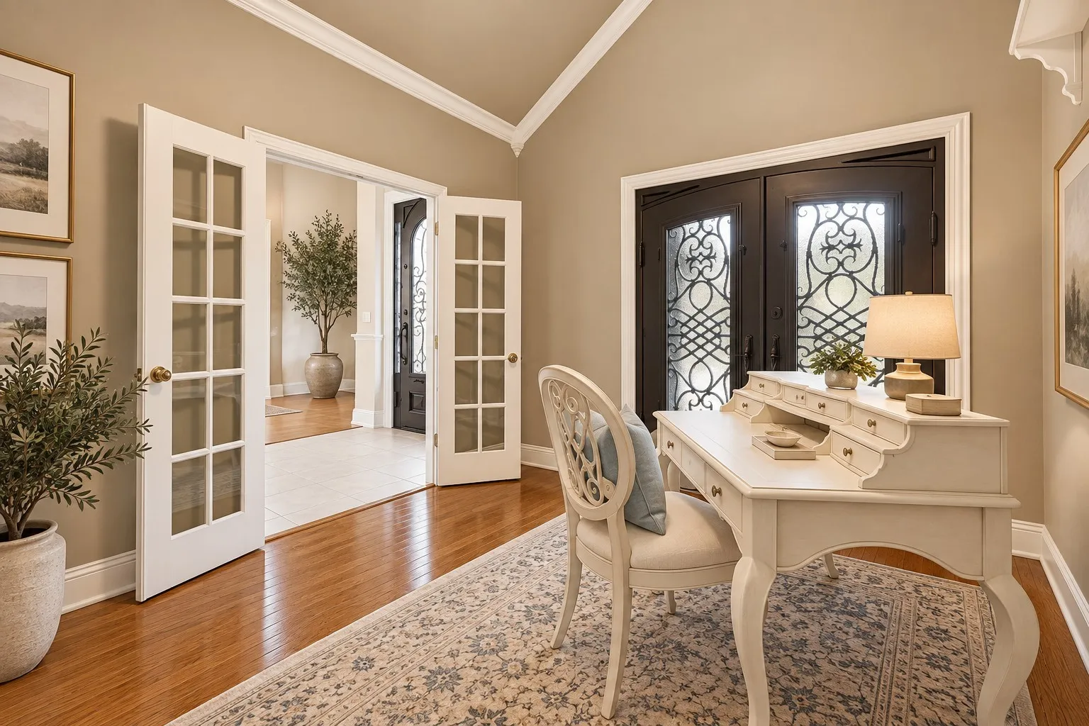 Hardwood flooring, elegant French doors, decorative front entry doors, and vaulted ceilings