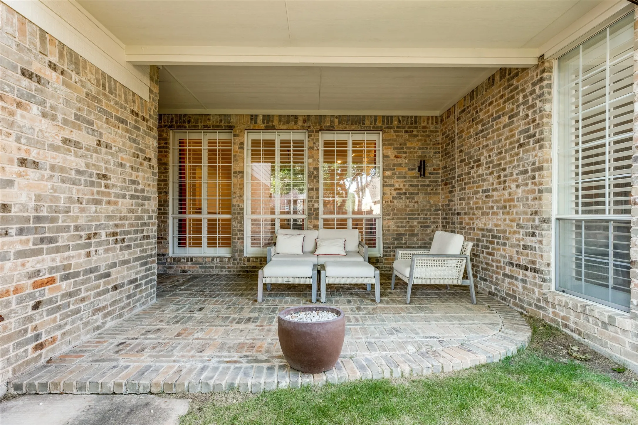 Covered patio featuring a brick paver surface and recessed lighting