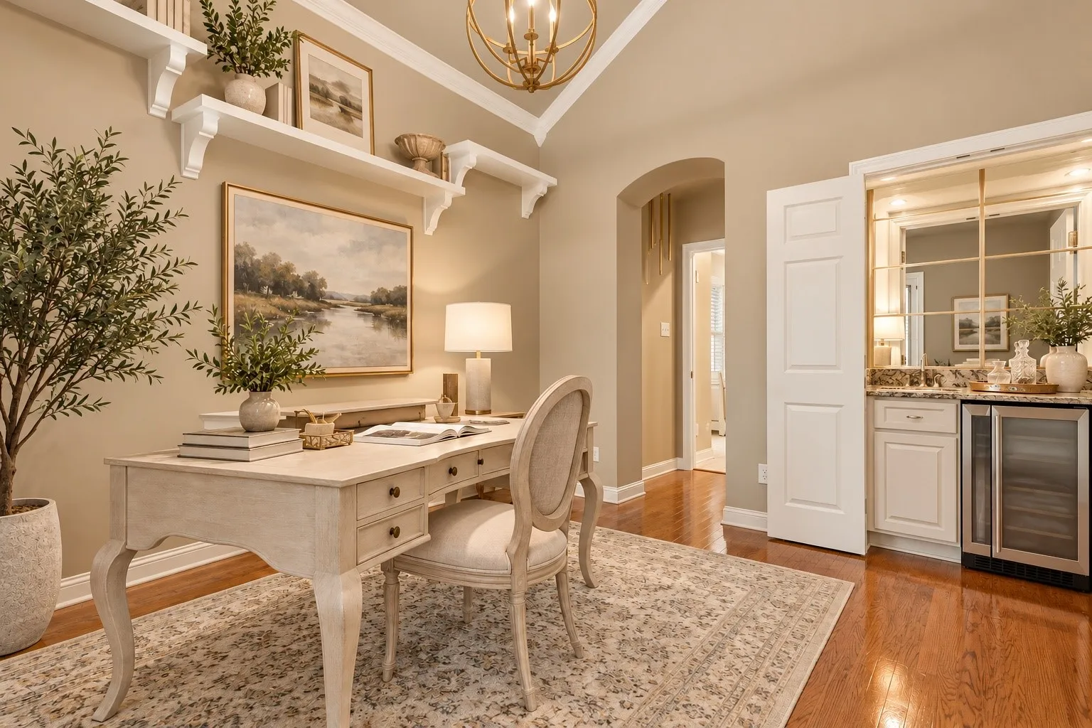 Vaulted ceiling with an ornate chandelier, built-in shelving, wood-finish flooring, built-in cabinetry, and a mirrored wet bar