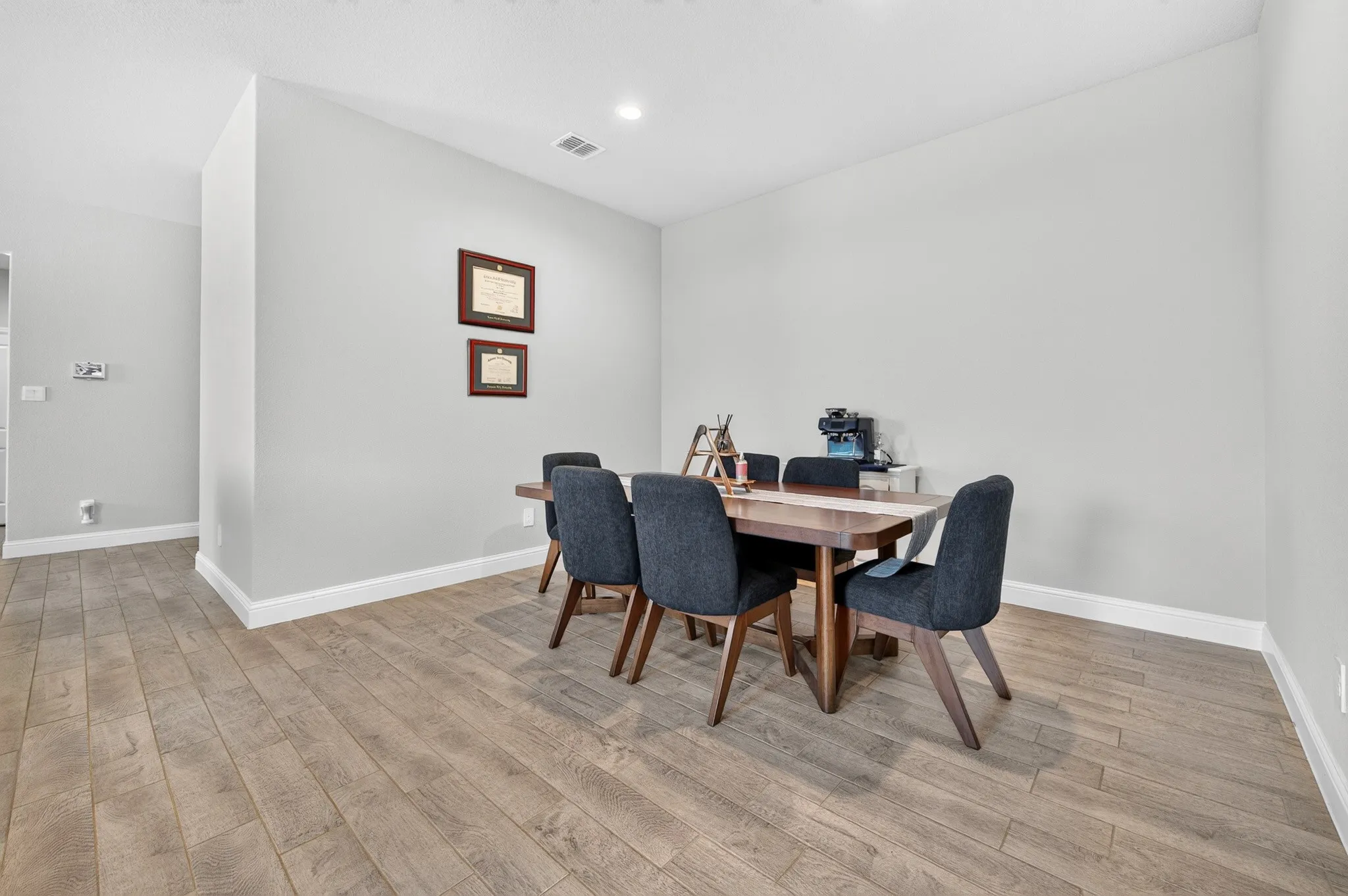 Spacious room with wood-finish flooring and neutral wall tones