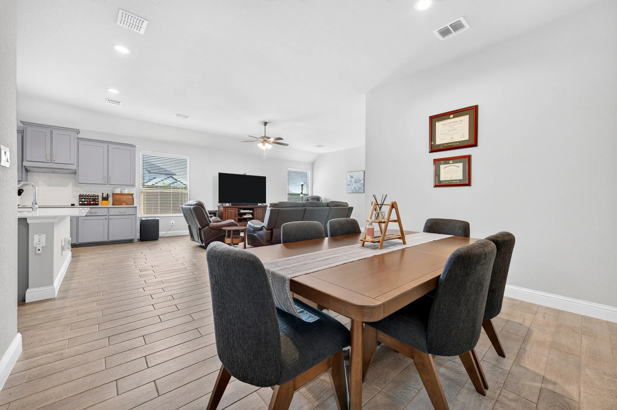 Dining area with wood-finish flooring, recessed lighting, and a neutral wall palette